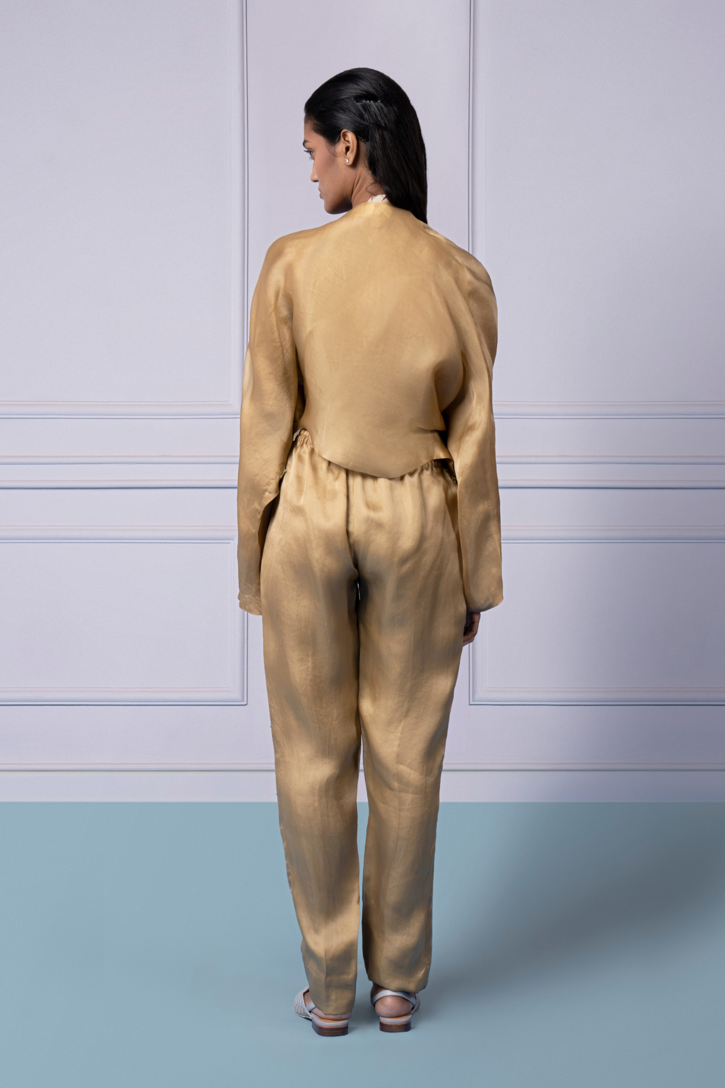 Back view showing the Misfit jacket and organza pants set, emphasizing the elegant cut and detailed embroidery