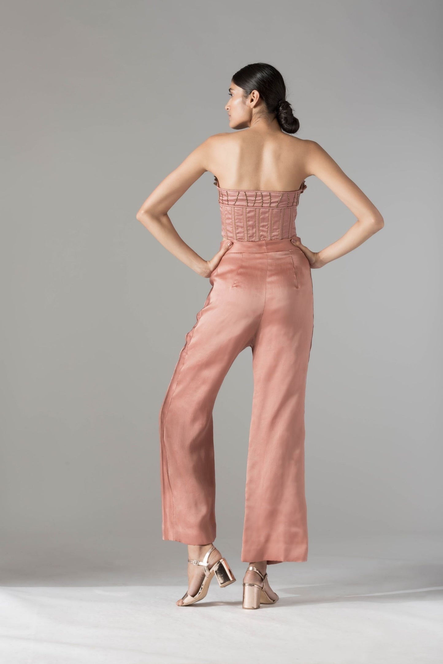 Back view of the designer top pant set, showcasing the clean lines, rope tie-ups, and elegant silhouette of the pants and top
