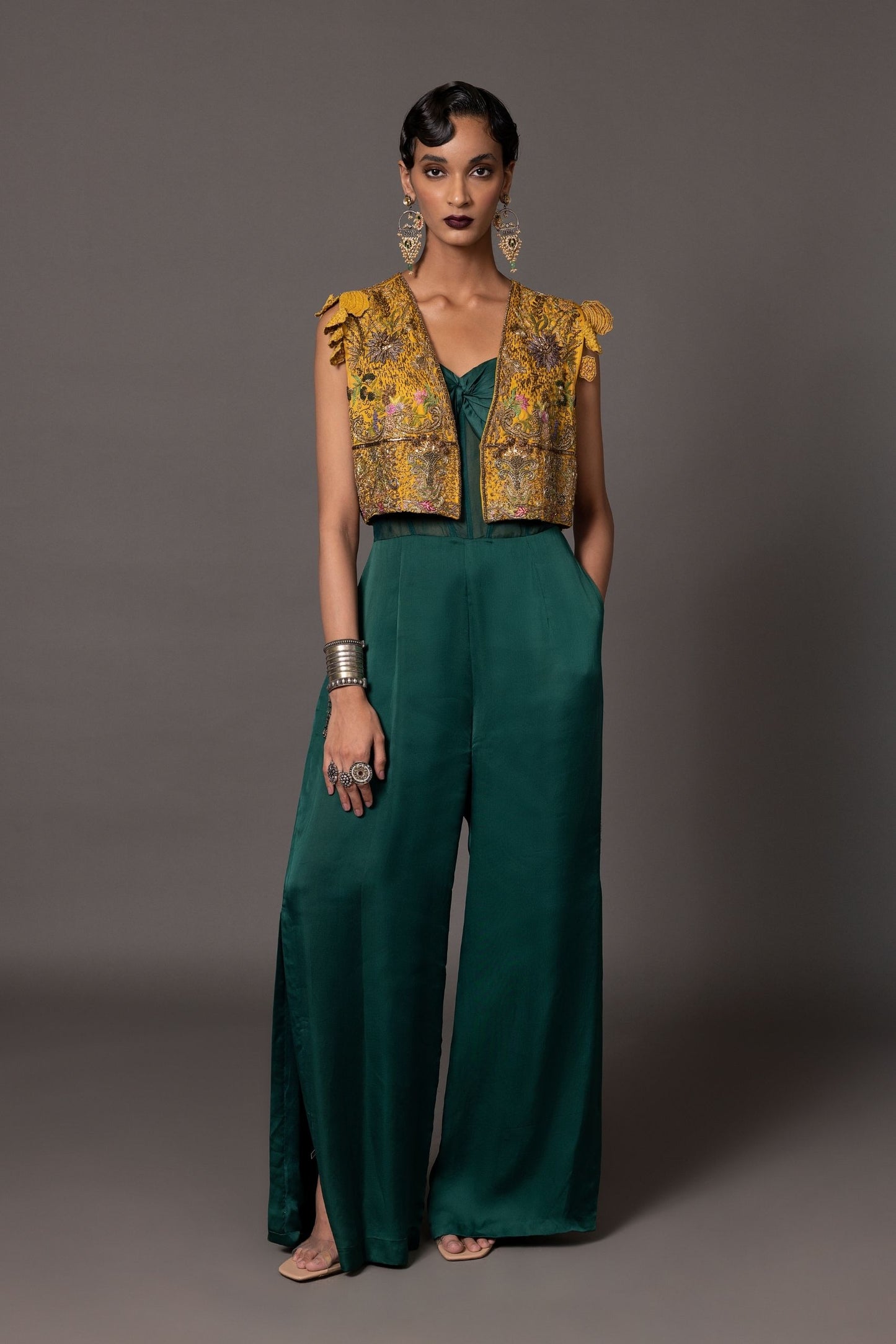 Namib Bottle Green Women's Jumpsuit with knotted bodice and sheer corset, paired with Paro Cropped Embroidered Jacket featuring Zardosi handwork