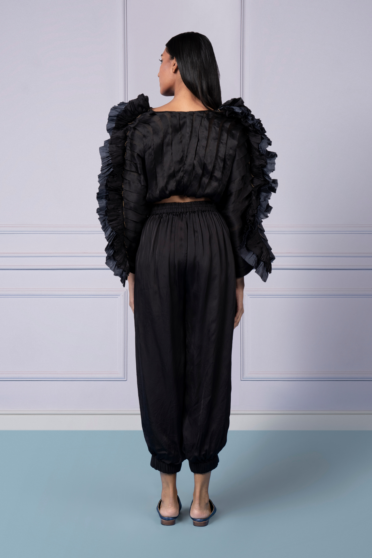 Back view showing the pleated organza top and the elastic waist of the joggers for a perfect fit
