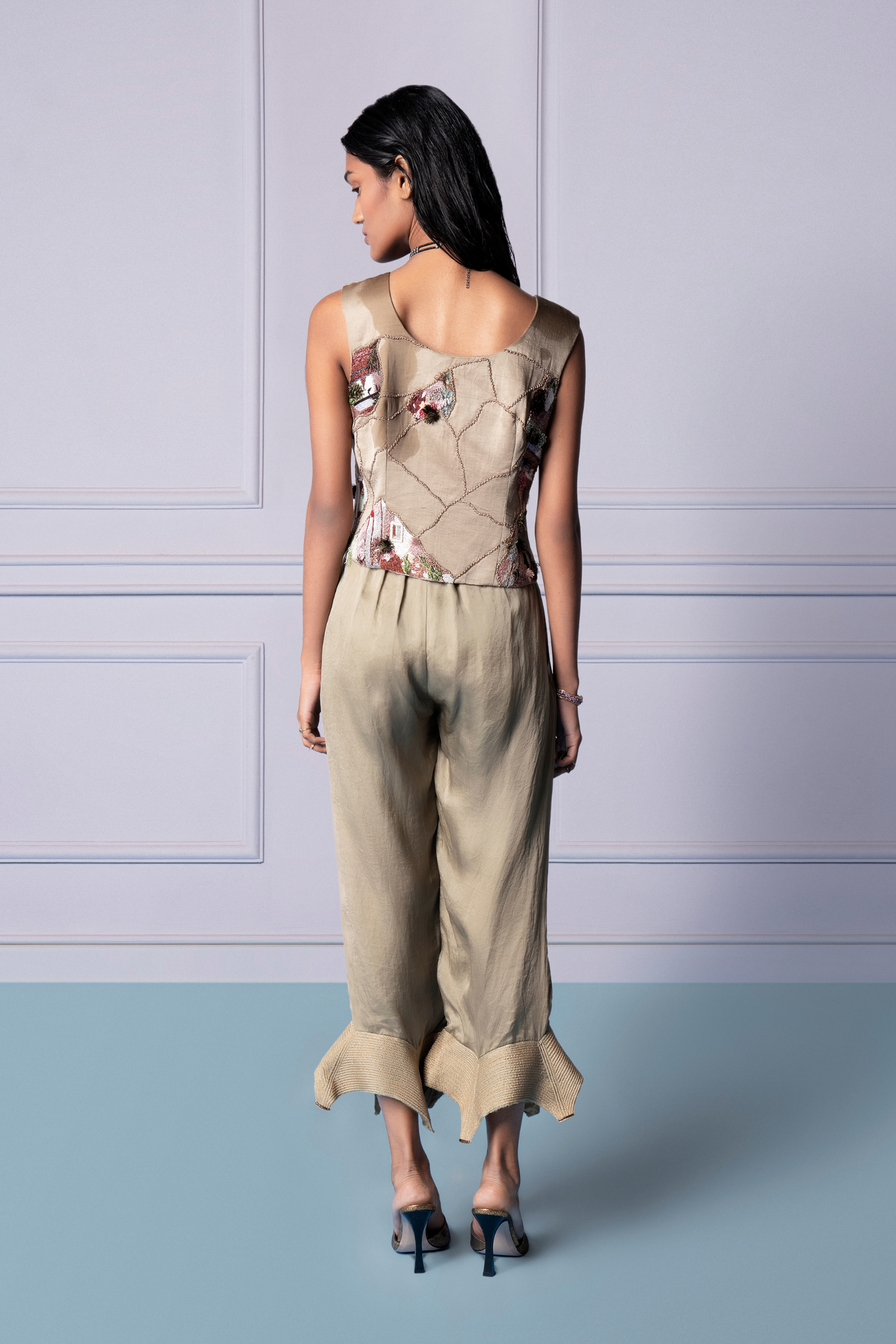 Back view of the designer waistcoat and luxury pants, highlighting the intricate Jacobean handwork