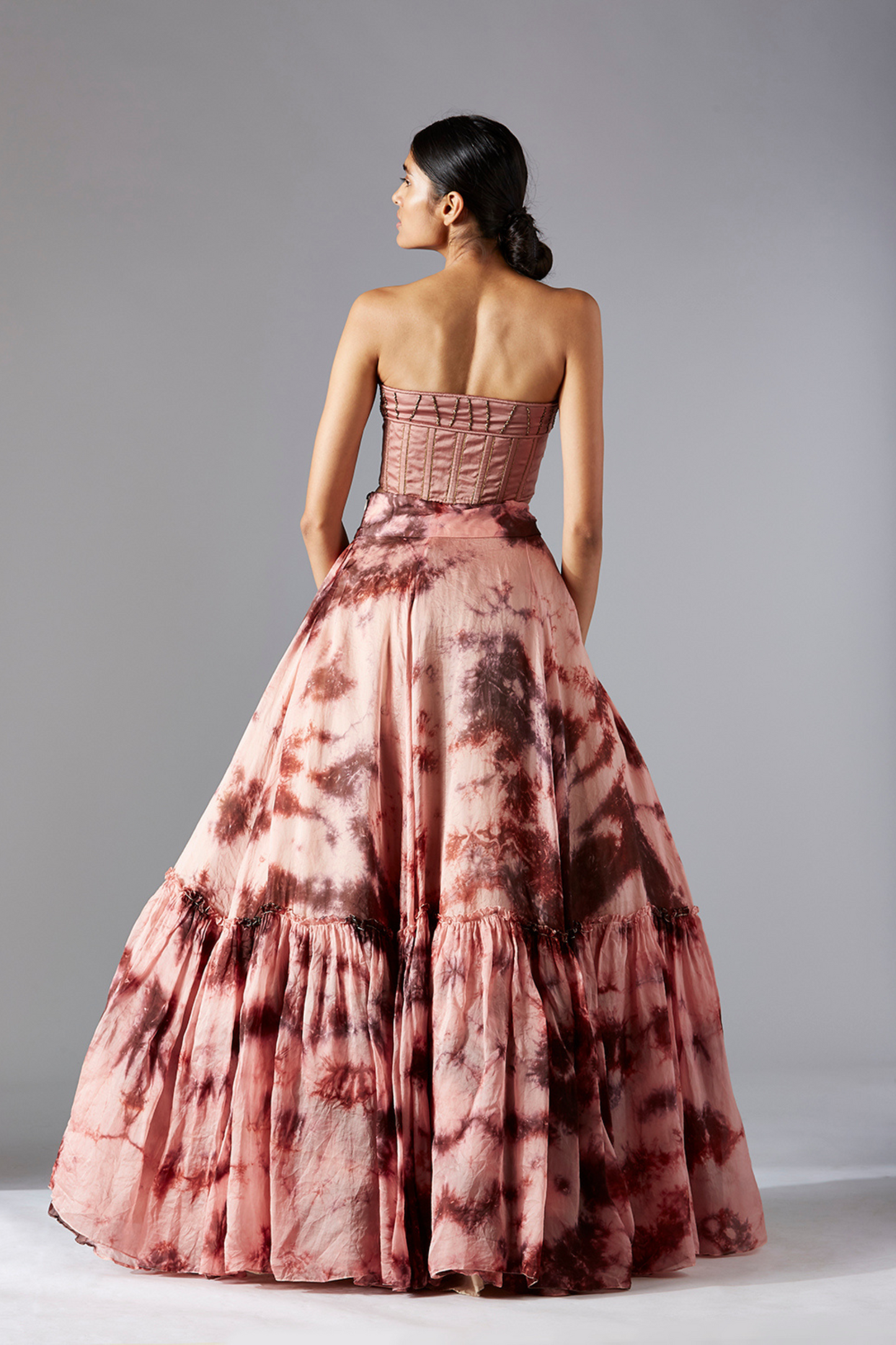Back view of the top skirt set for women, highlighting the corset-style top and flared skirt design