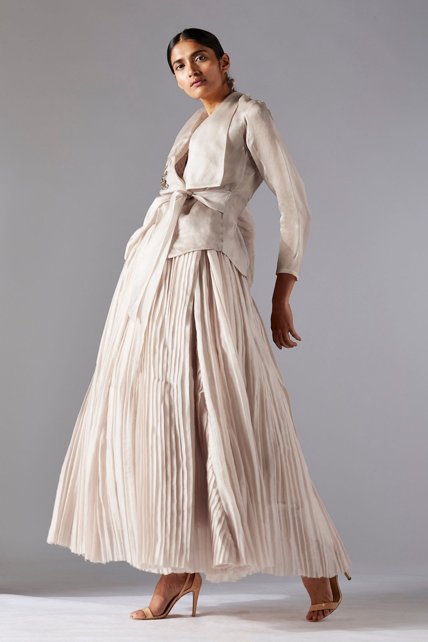 Stylish organza designer jacket with 3D metallic work, paired with a pleated ballroom skirt for a chic look
