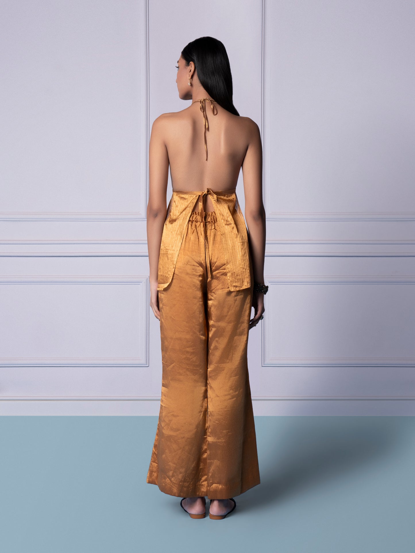 Back view of the Gold Chanderi bralette and trousers set for women, showcasing the sleek design and tailored fit