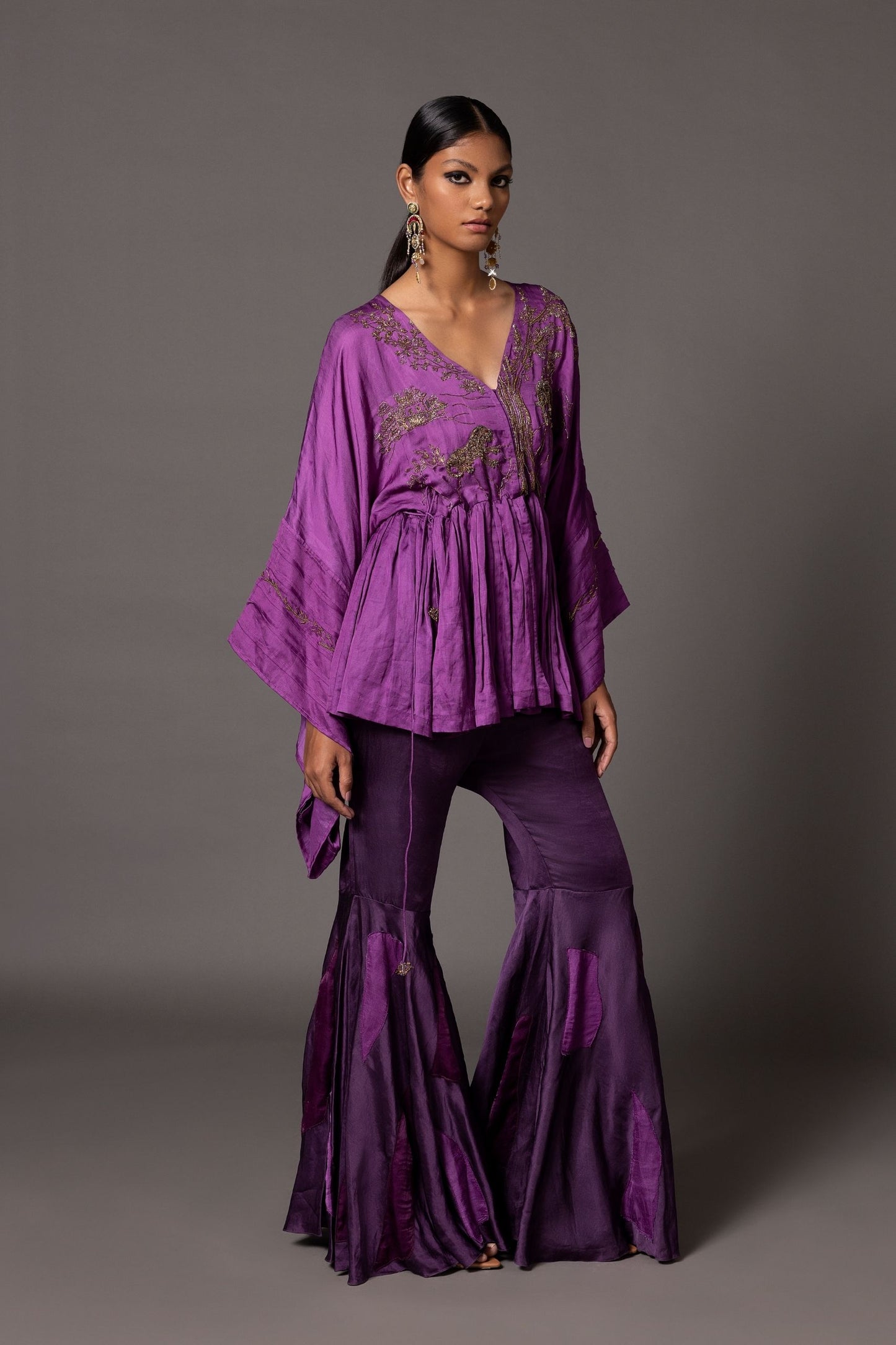 Full view of the Shikhar Baugh purple peplum top and fit-and-flare gharara pants with color-blocked patchwork