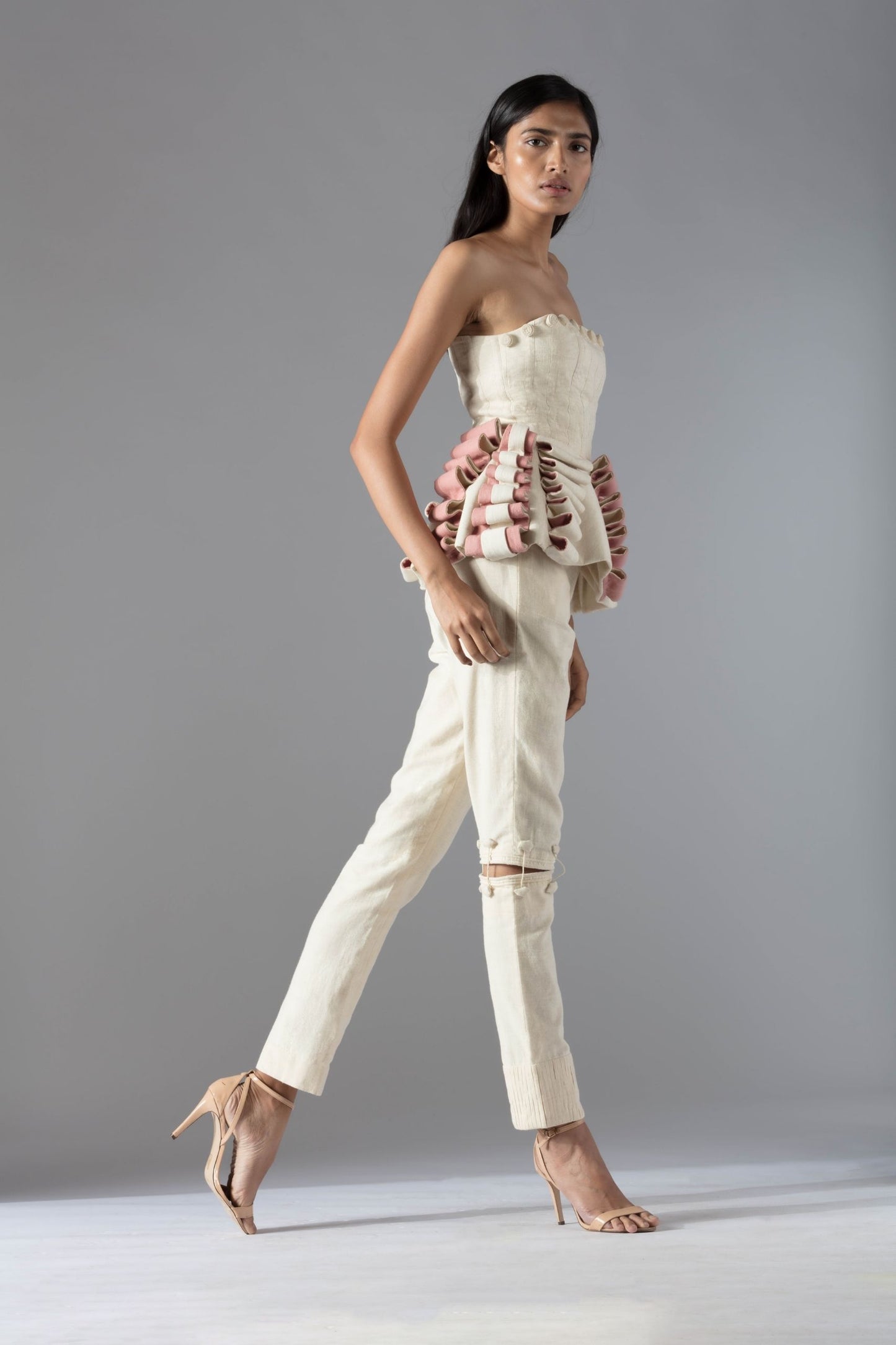 Side view of the peplum-style designer top in organic khadi, emphasizing the chic and flattering fit