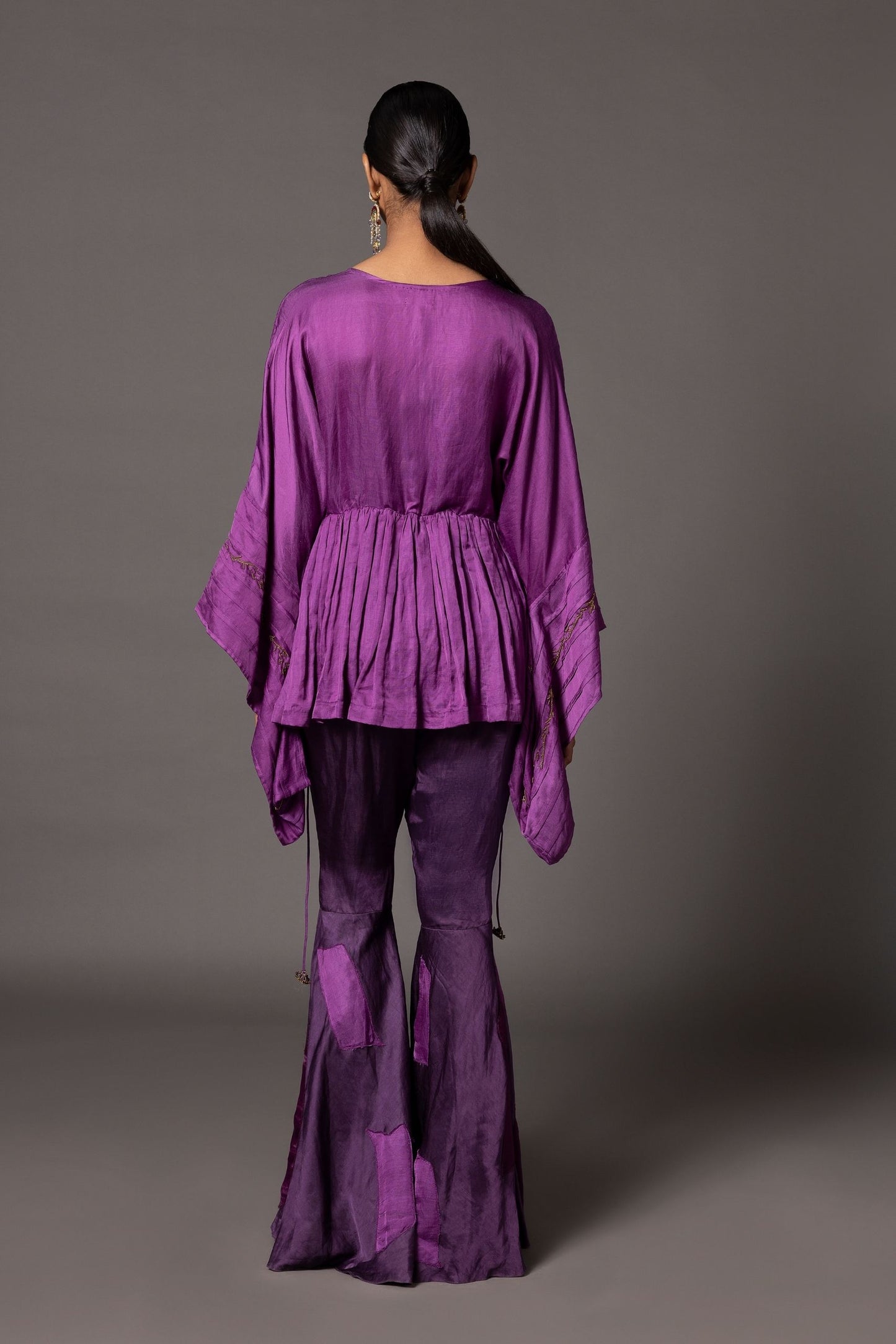Back view of the Shikhar Baugh peplum top and gharara, showcasing the design and color-blocked patchwork