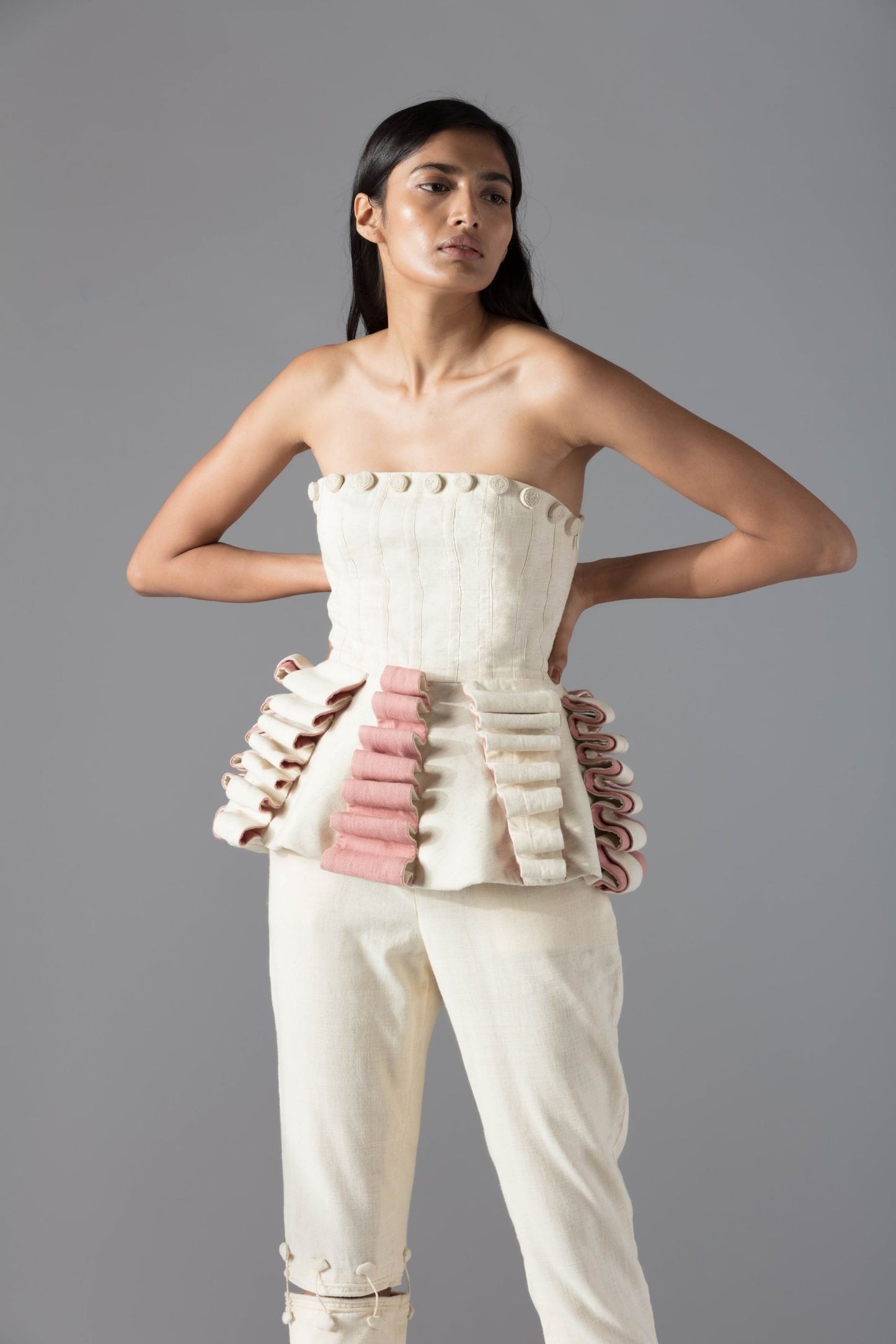 Stylish peplum-style designer top for women in organic khadi with handmade rose details, offering modern elegance