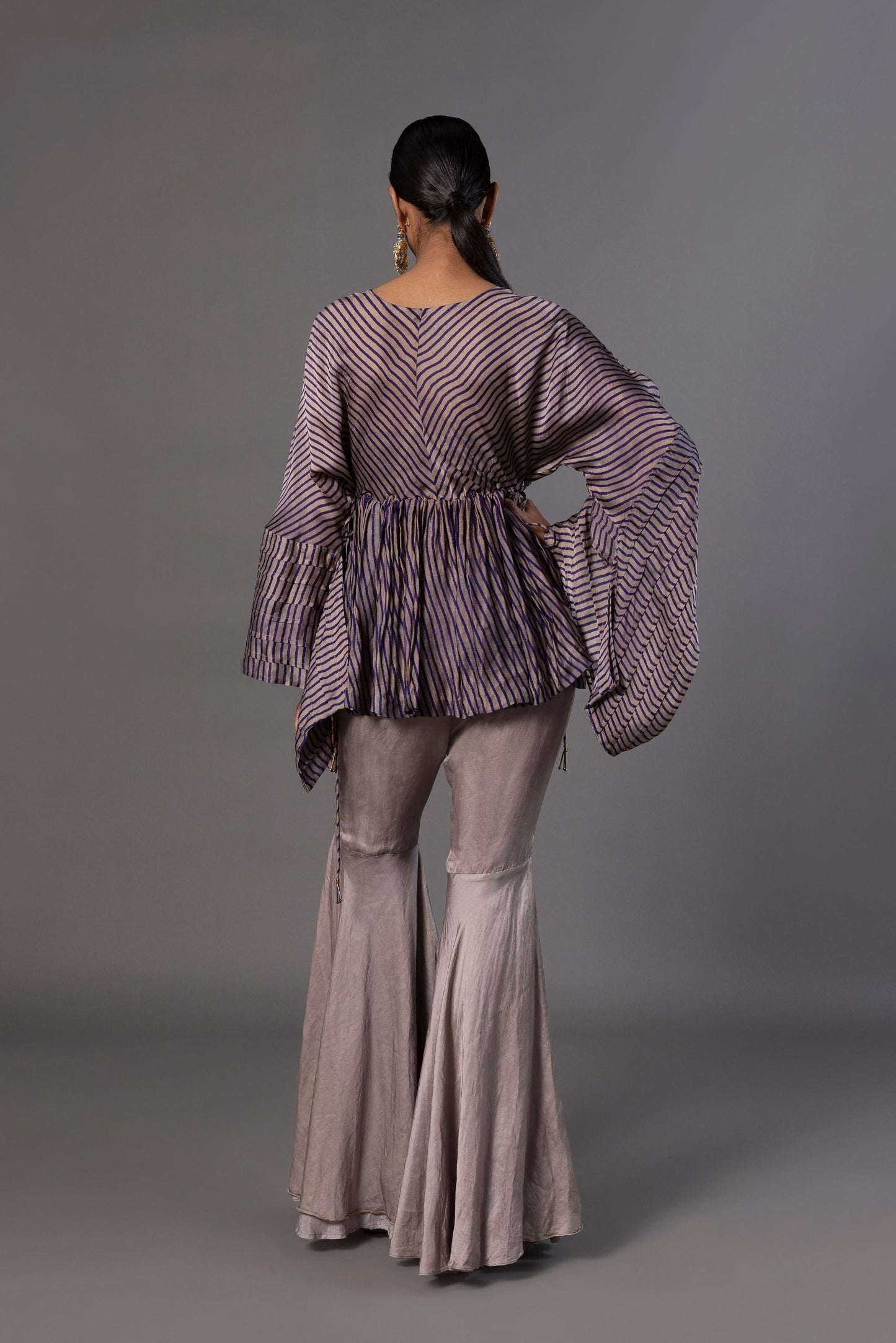 Back view of the Shikhar Baugh Peplum Top and grey gharara pants, showcasing the silhouette and embroidery details