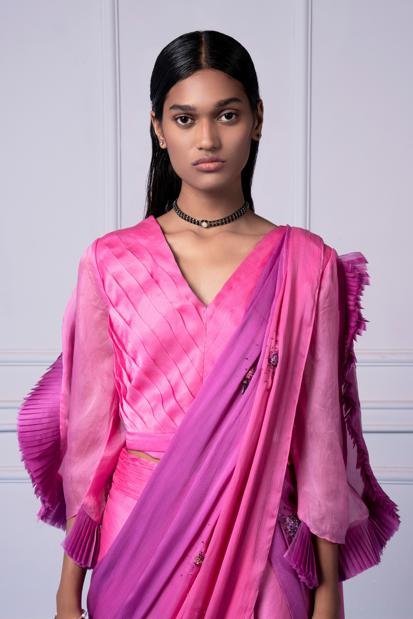 Close-up view of the pleated blouse and textured dupatta on the pink lehenga saree set, showcasing fine craftsmanship