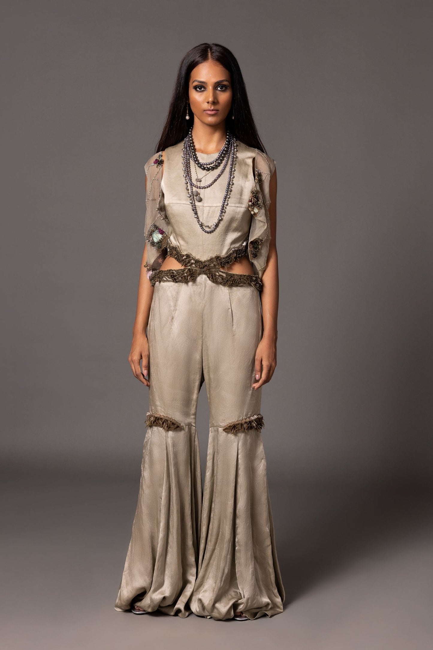 Grey sleeveless jumpsuit with 3D silver embroidery, flared lower, paired with hand-embroidered organza jacket featuring metallic and textured details from A Humming Way