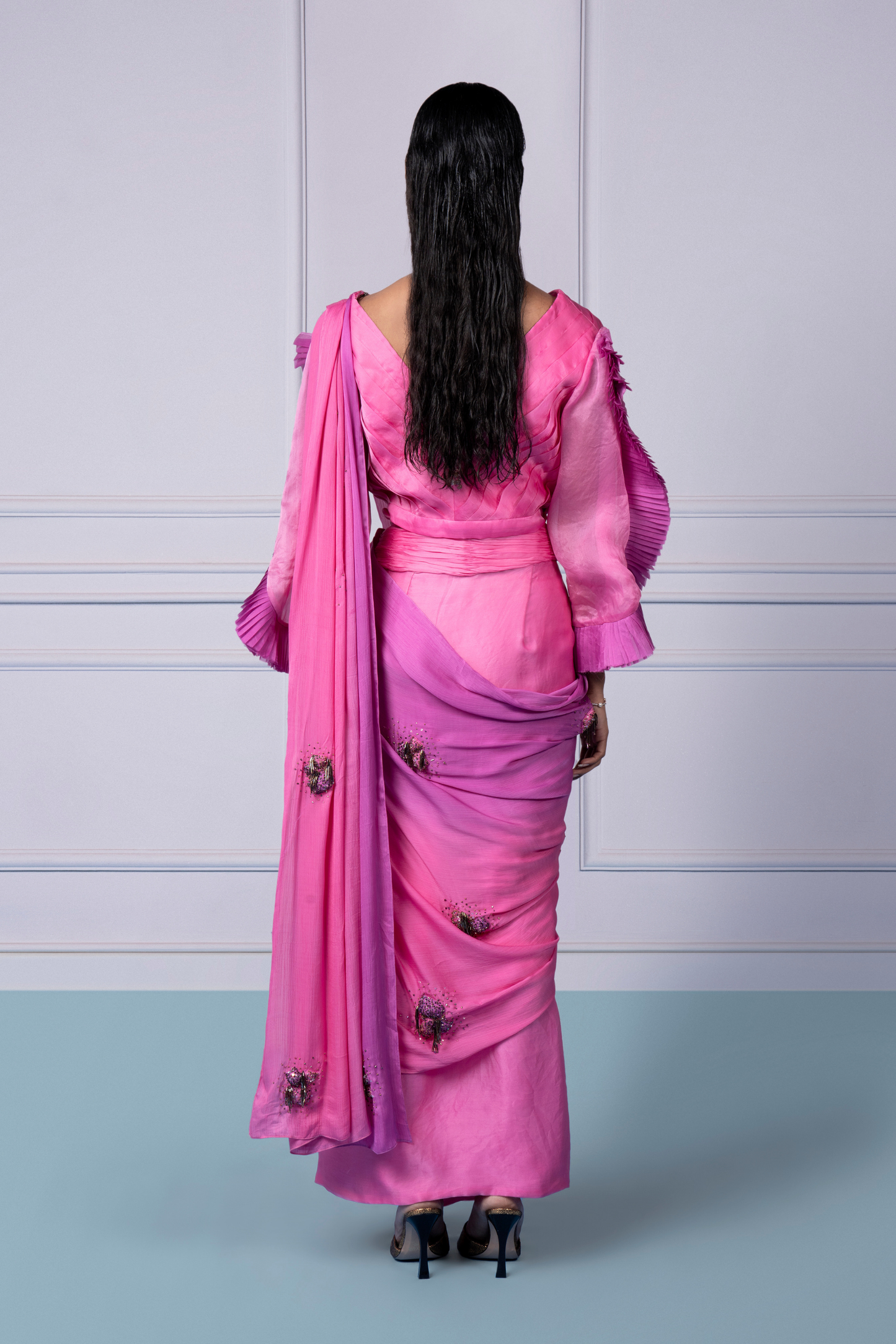 Back view of the pink lehenga saree, showcasing the textured dupatta and sleek drape of the set