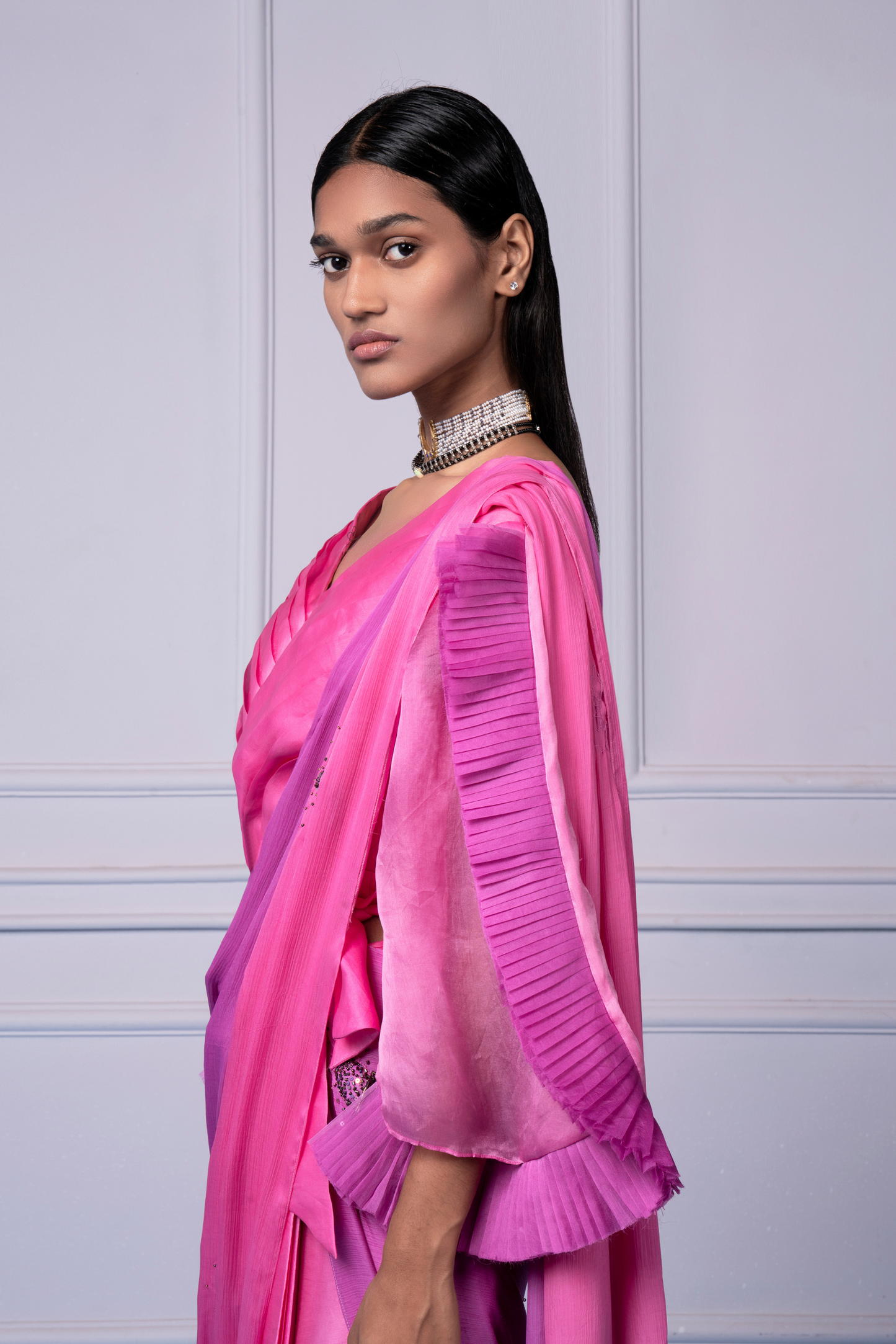 Focused view of the pleated blouse and textured dupatta, highlighting intricate details on the pink lehenga saree set