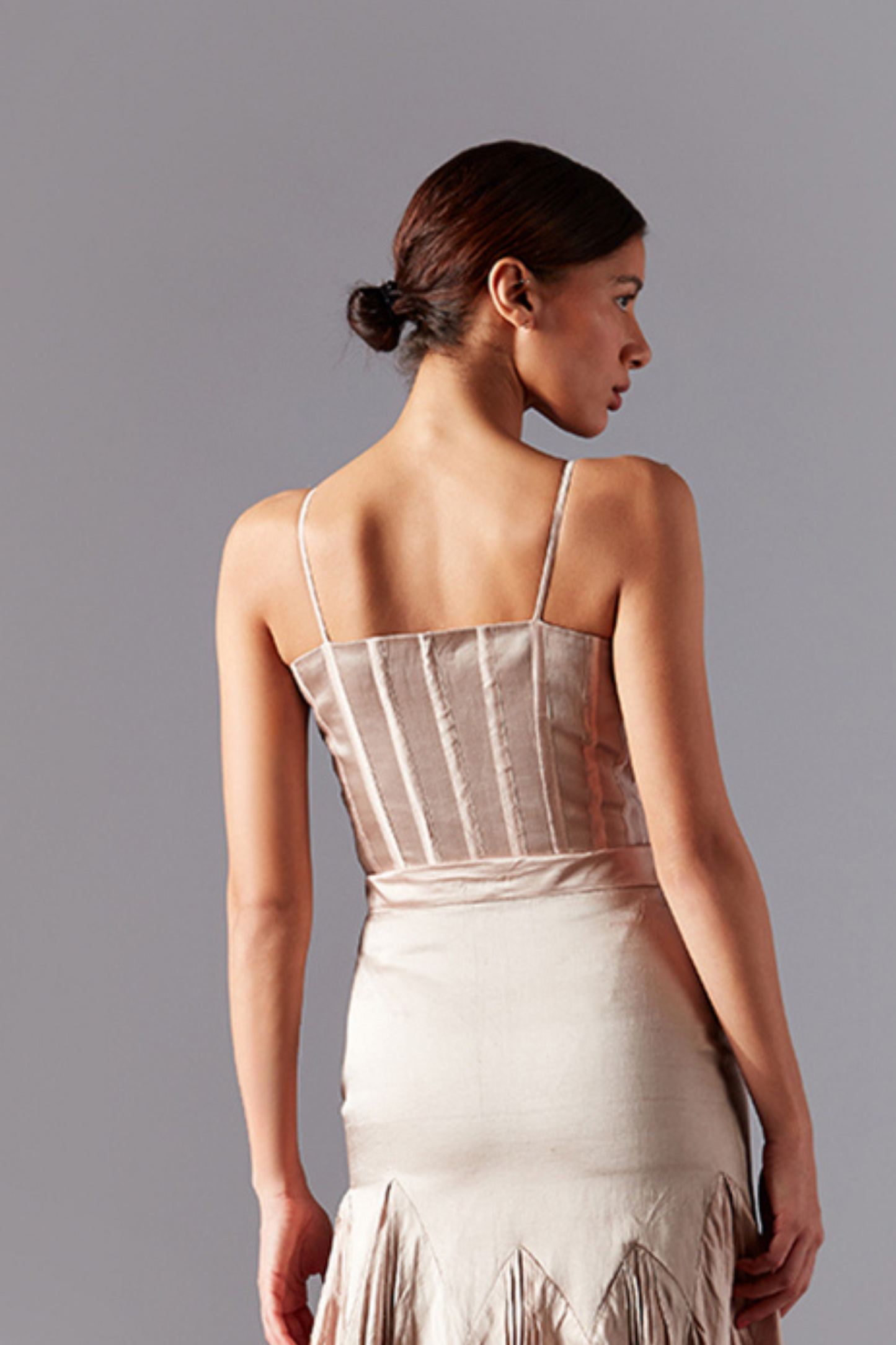 Back view of the designer top, showcasing the intricate embroidery and structure of the bouquet corset design