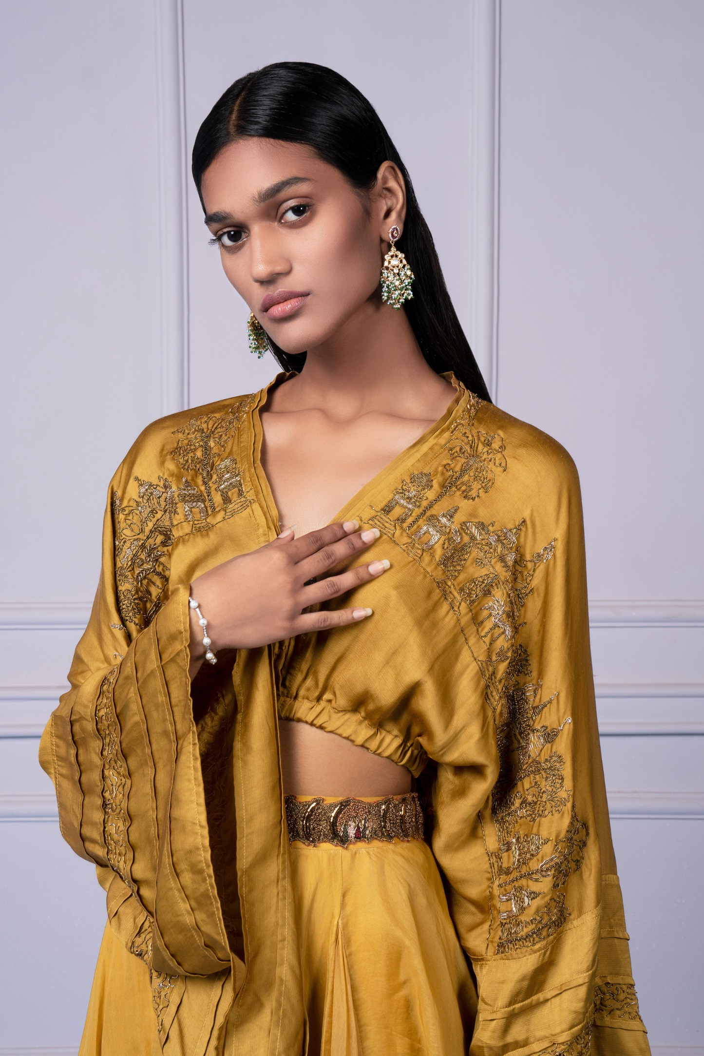 Focused view of the metallic embroidery on the yellow kimono top, highlighting the luxurious craftsmanship
