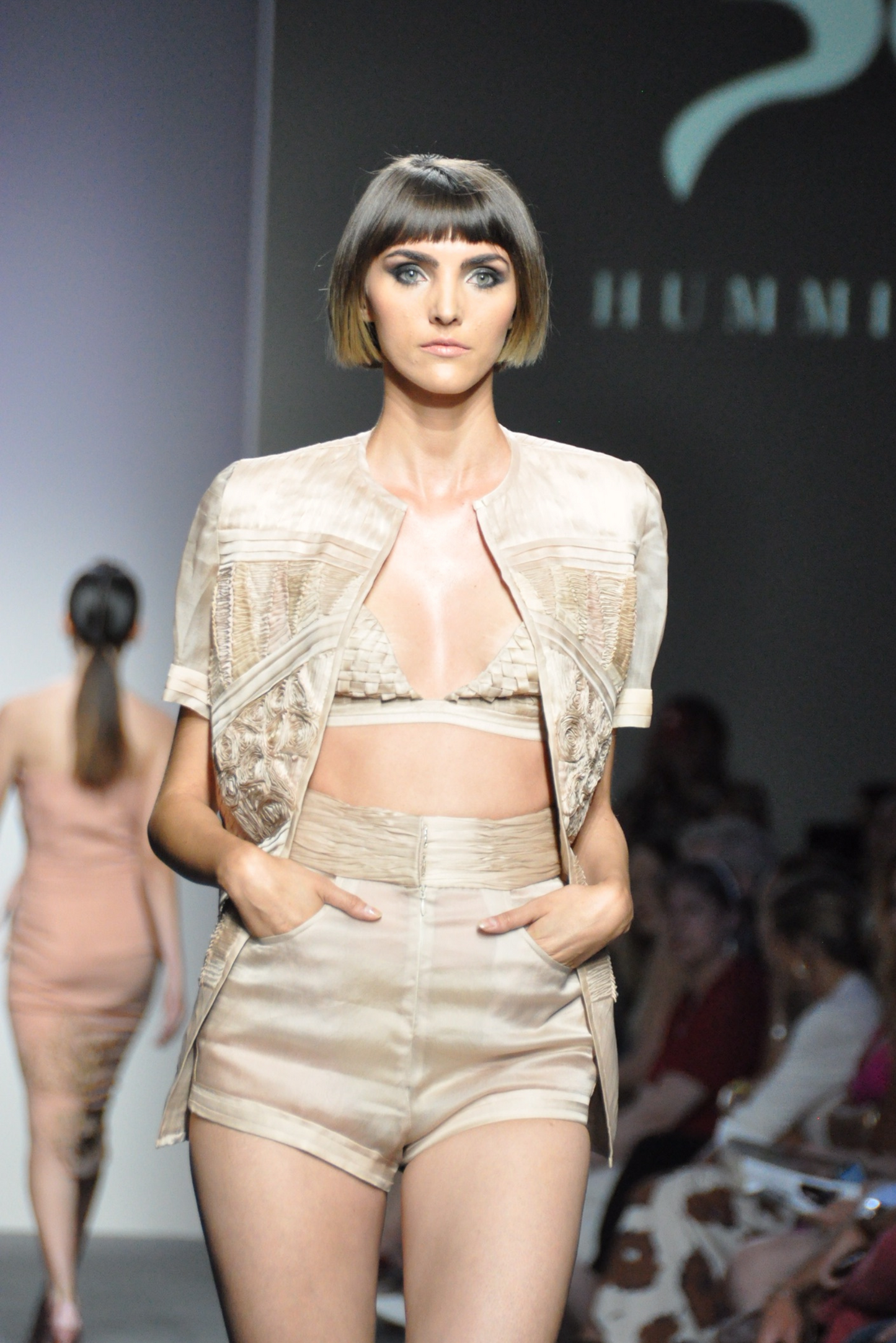 Model wearing the designer fabric manipulation jacket, highlighting its stylish geometric patterns and handmade details for a chic, modern look