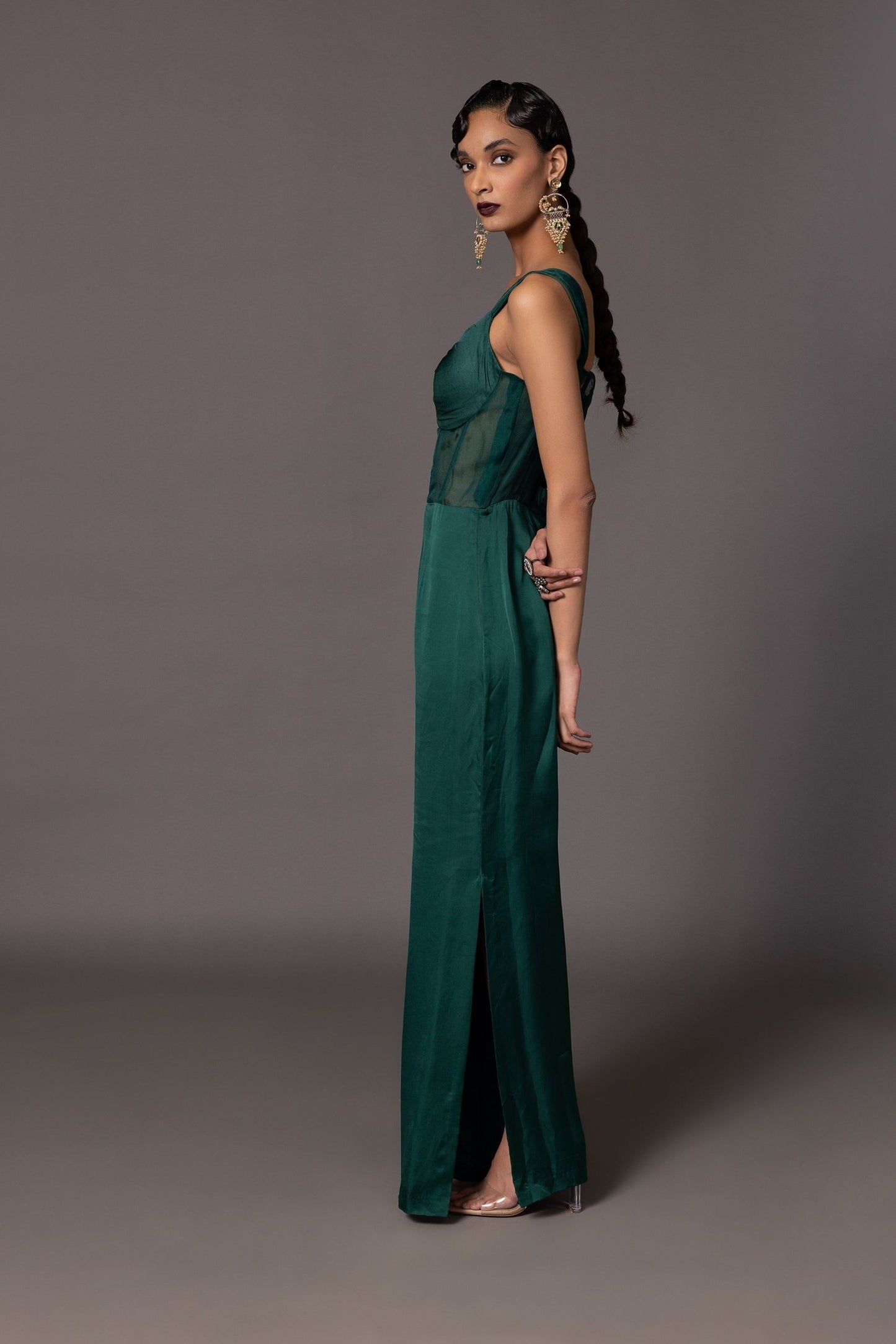Side view of the Namib Bottle Green Women's Designer Jumpsuit, showcasing the sleek silhouette and side slits