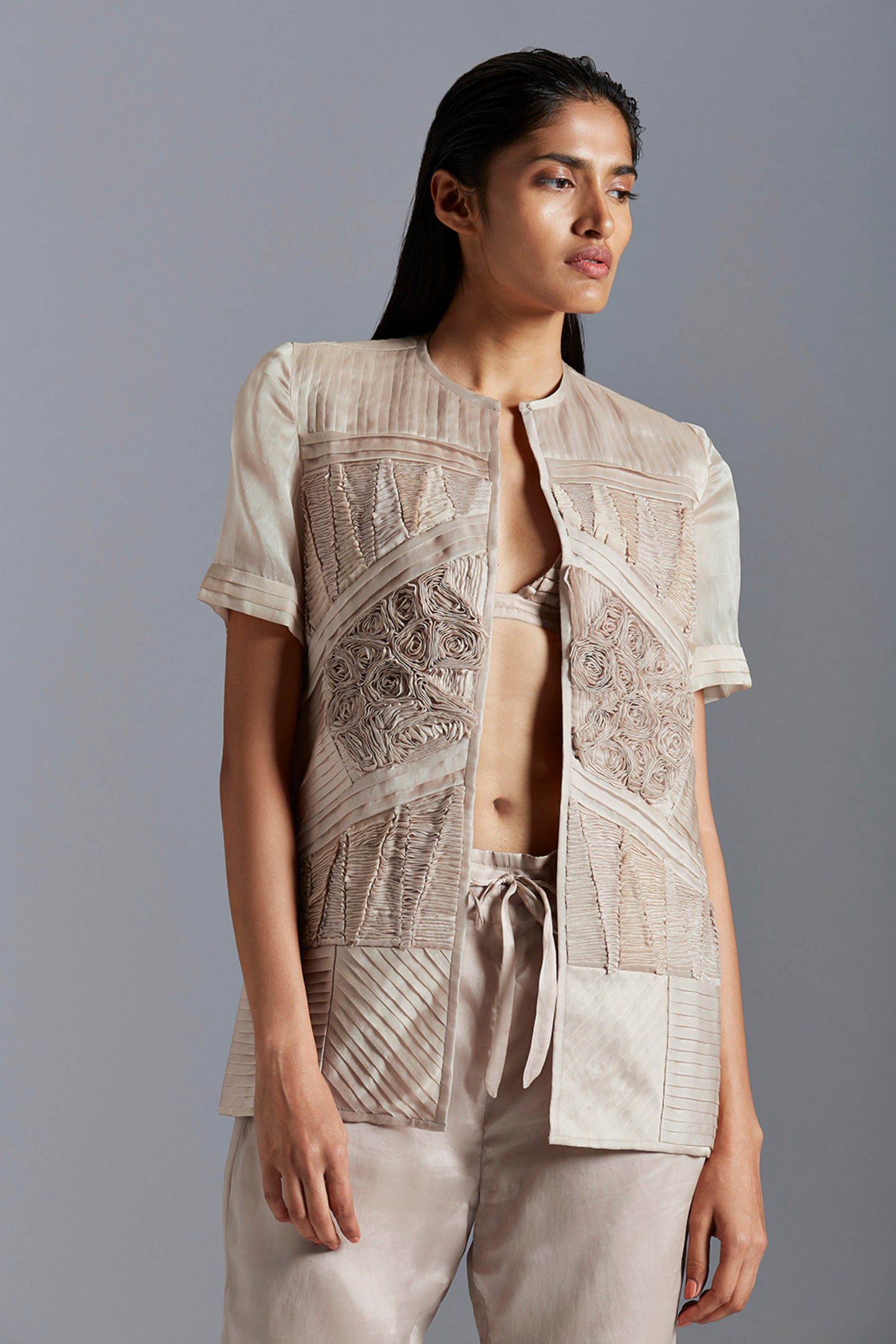 Fabric manipulation jacket, emphasizing the jacket’s sleek structure and geometric pattern details