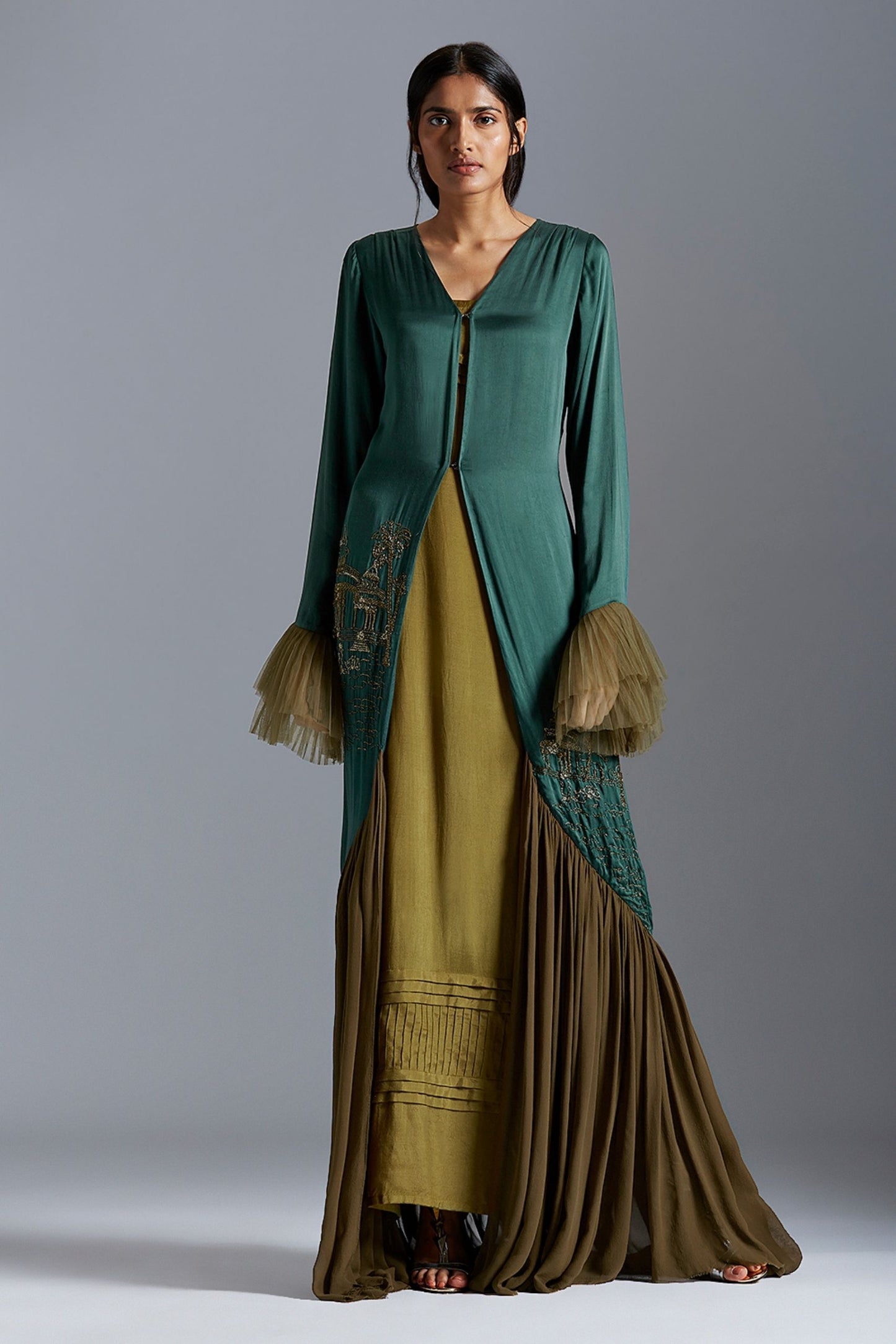 Designer gown for women featuring metallic hand embroidery inspired by Indian architecture, a modern and stylish long dress