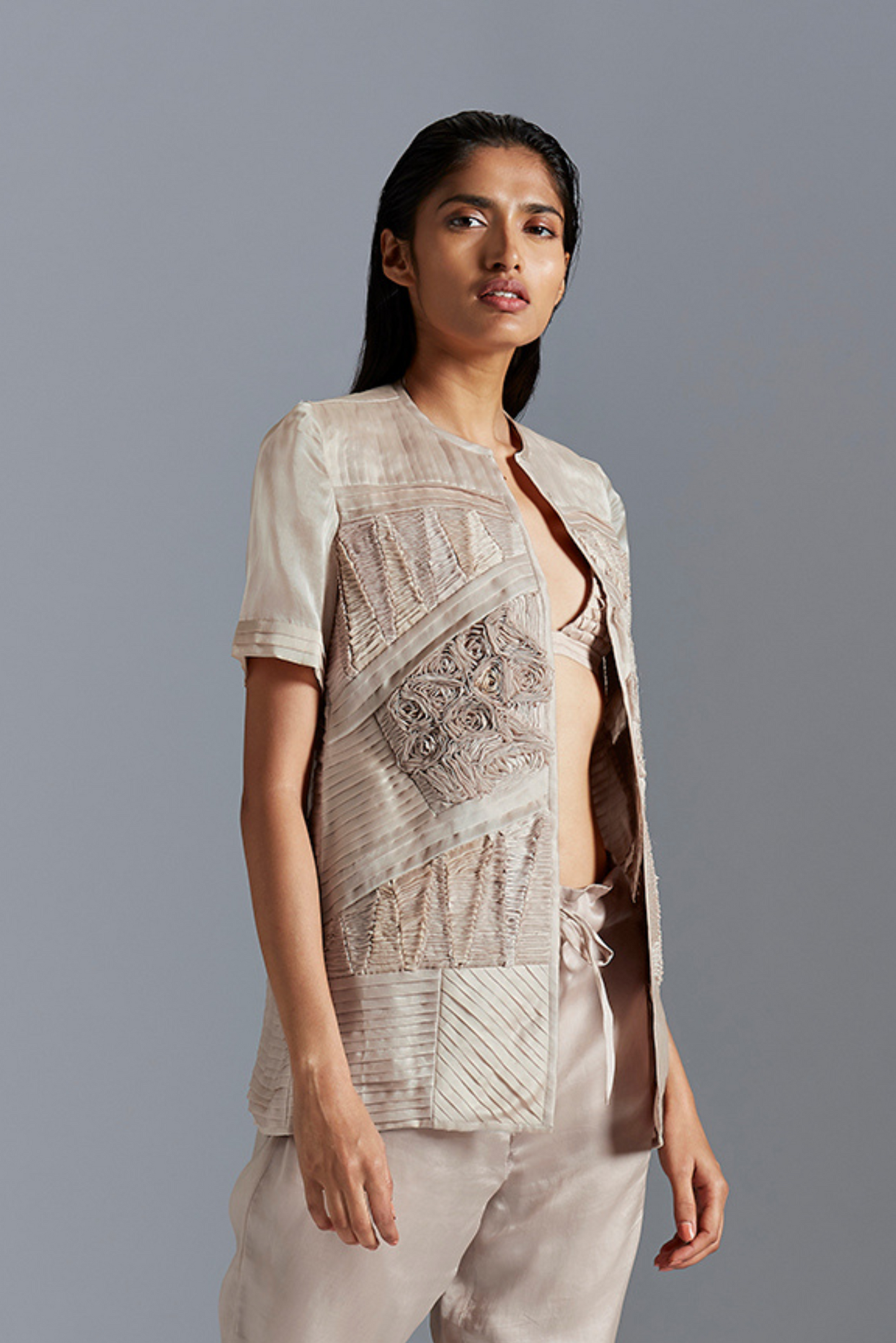Designer fabric manipulation jacket for women, showcasing the geometric patterns and handmade details