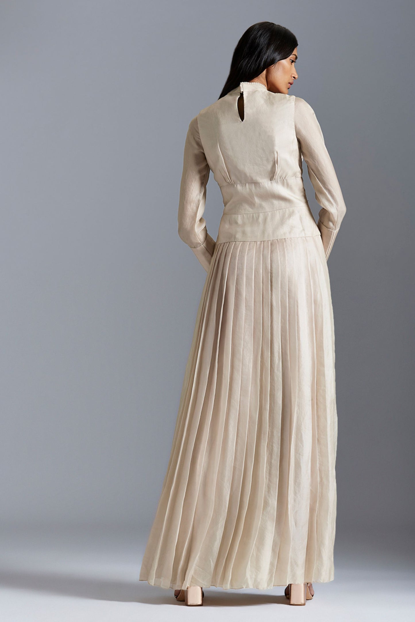 Back view of the designer Victorian gown, showcasing the pleating and intricate Mukaish detailing