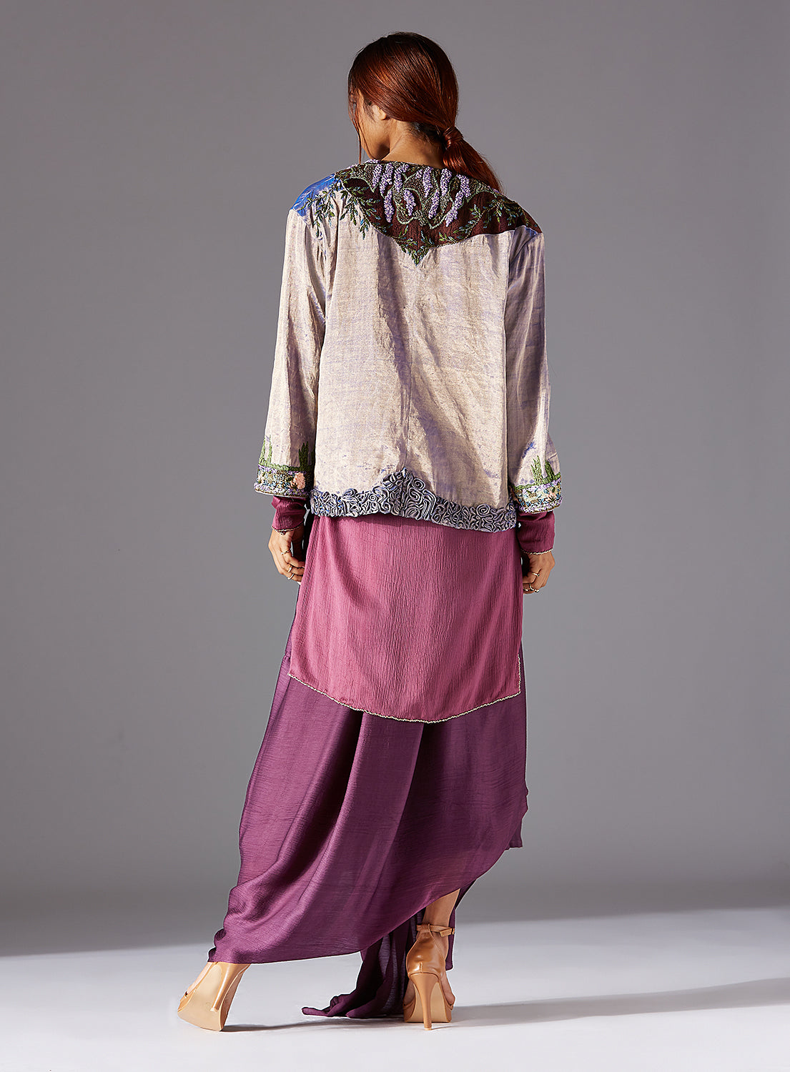 Back view of the jacket, displaying the seamless tailoring and intricate embroidery details on the back panel