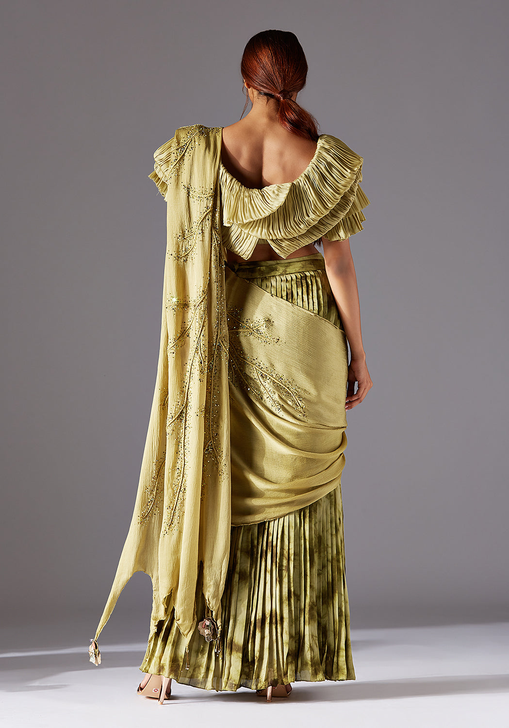 Back design of the blouse and full view of the stole draped elegantly with the pleated skirt