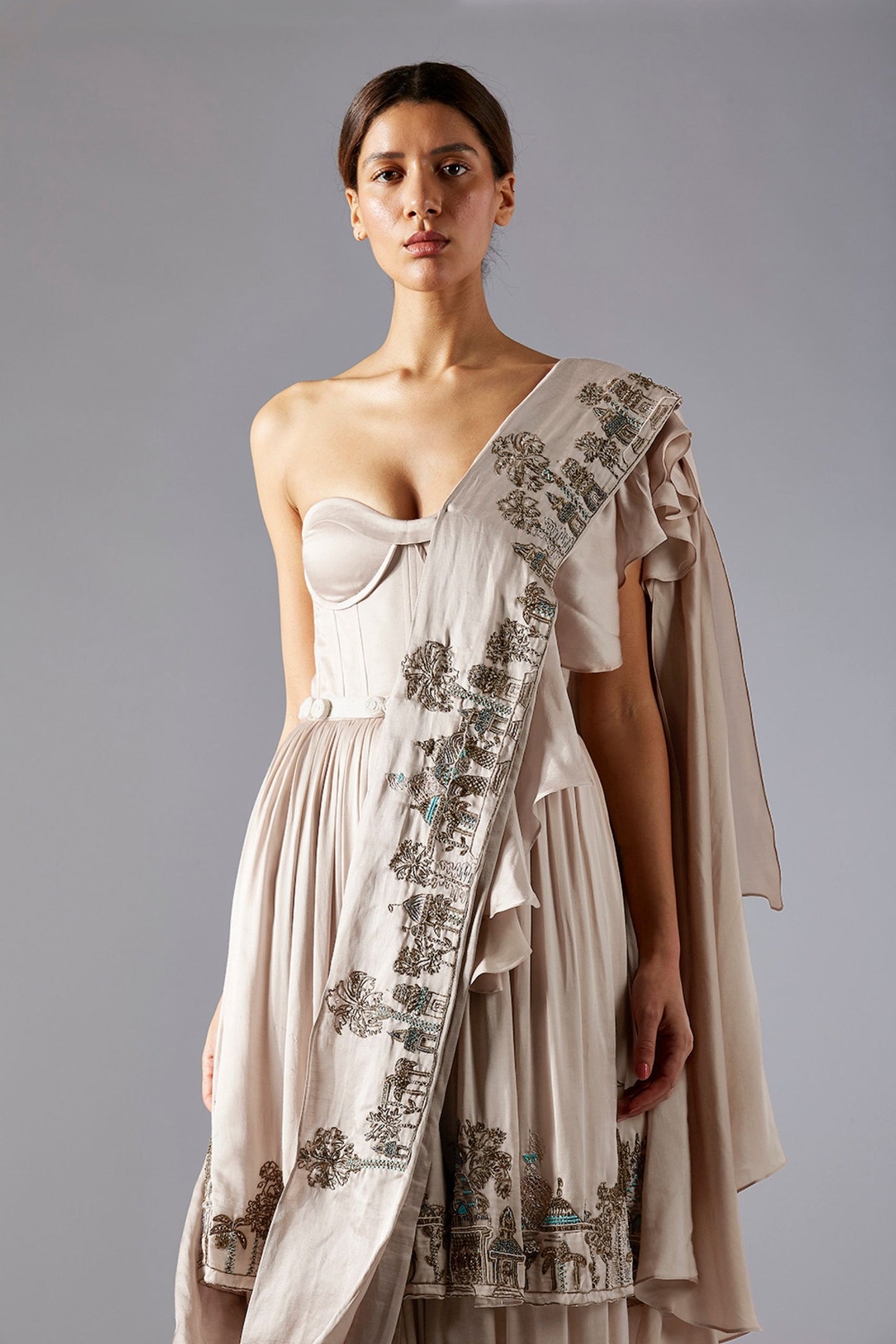 Close-up of the golden metallic handwork on the Indo Western gown, showcasing the intricate design and luxurious craftsmanship