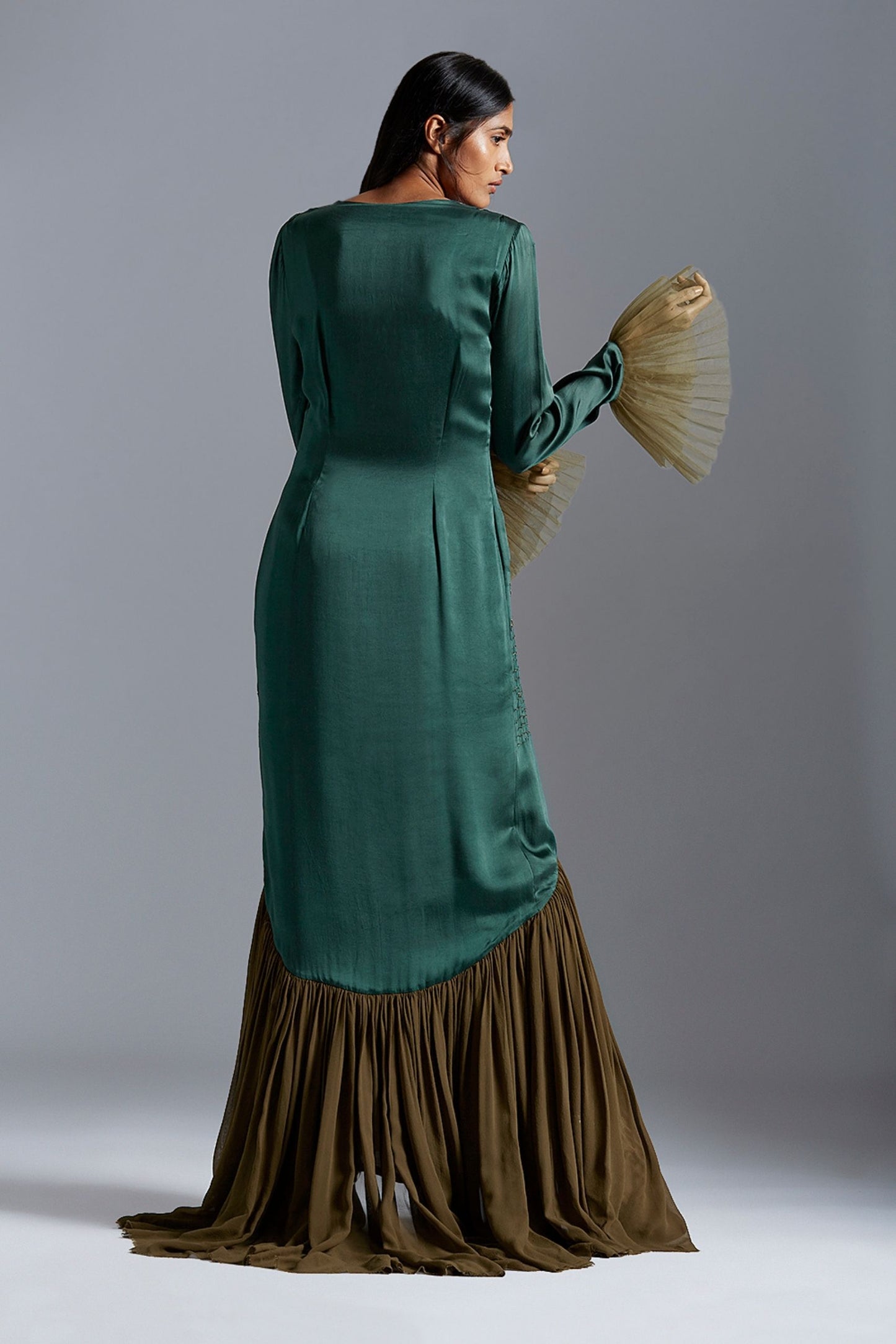 Back view of the designer gown, showcasing the elegant fit and detailed embroidery across the gown's back