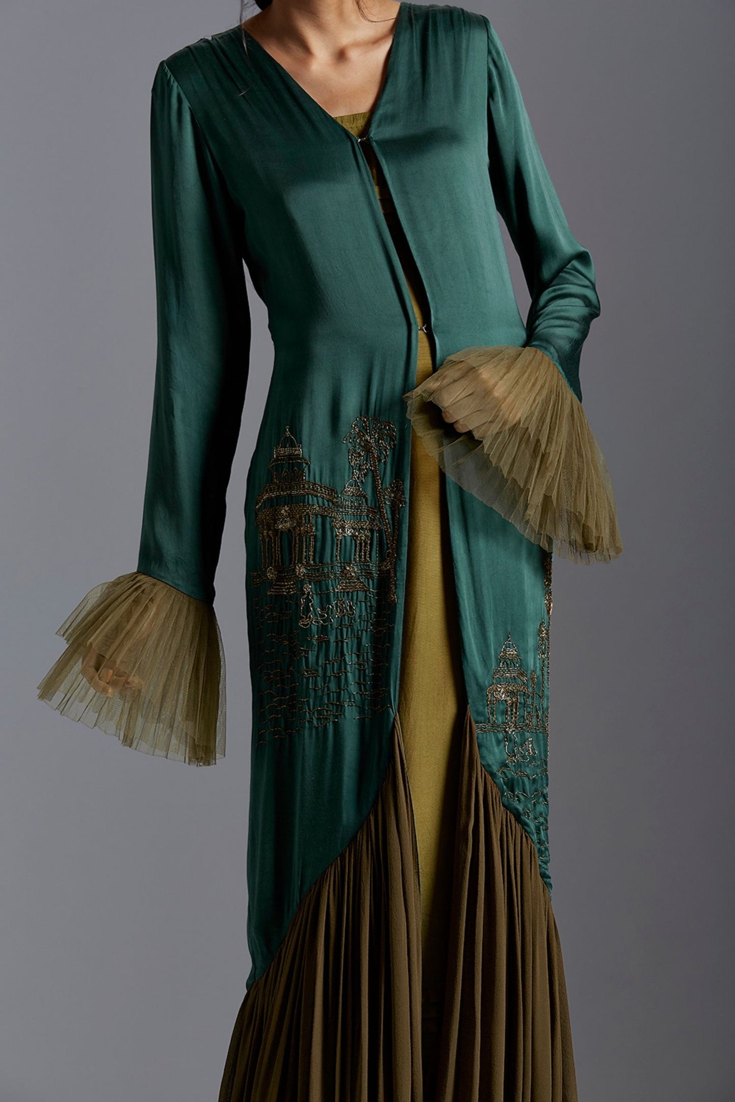 Close-up of the metallic hand embroidery on the gown, highlighting the intricate design inspired by Indian architecture