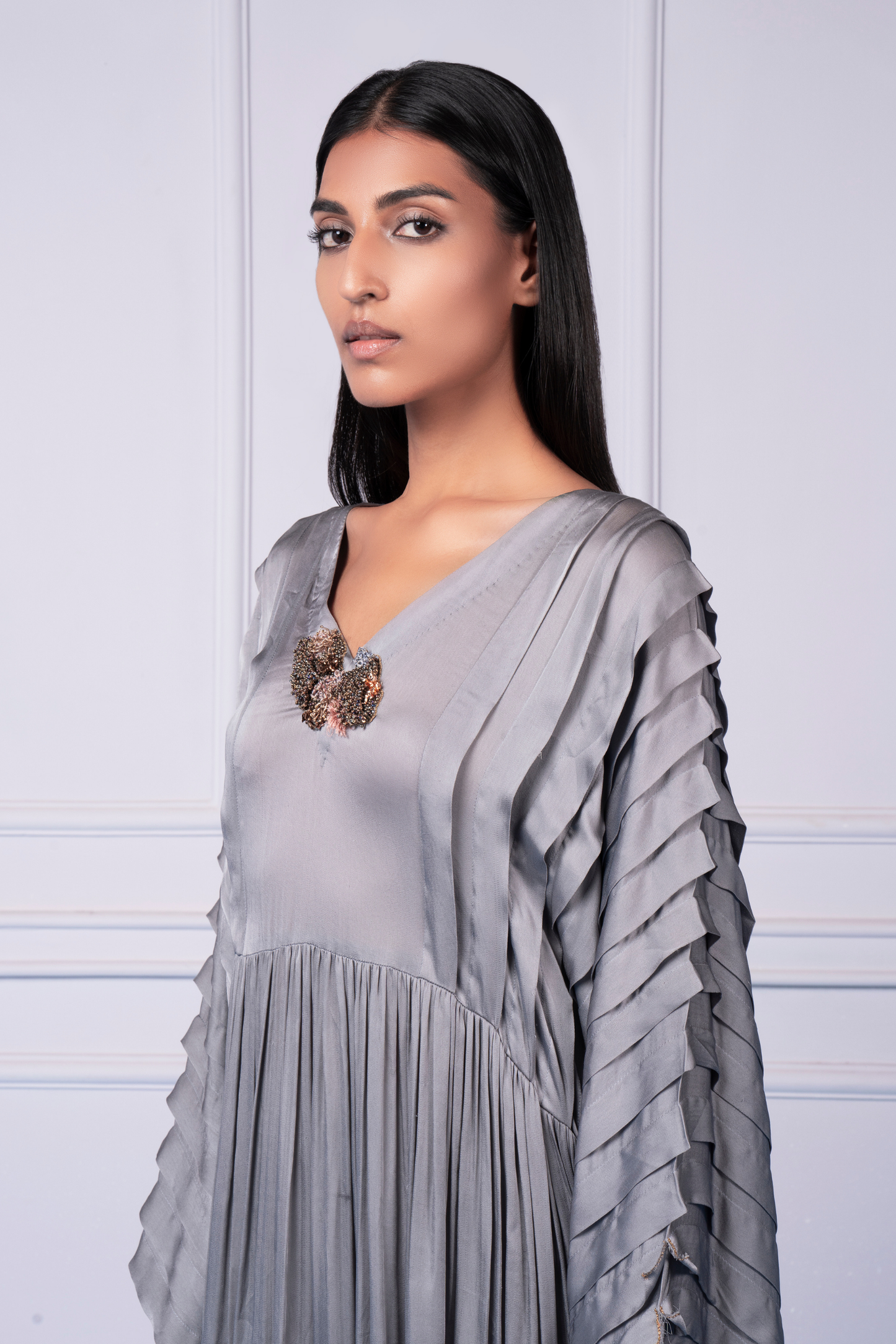Side view of modern kurta with mushroom pleats and high-low hemline for women