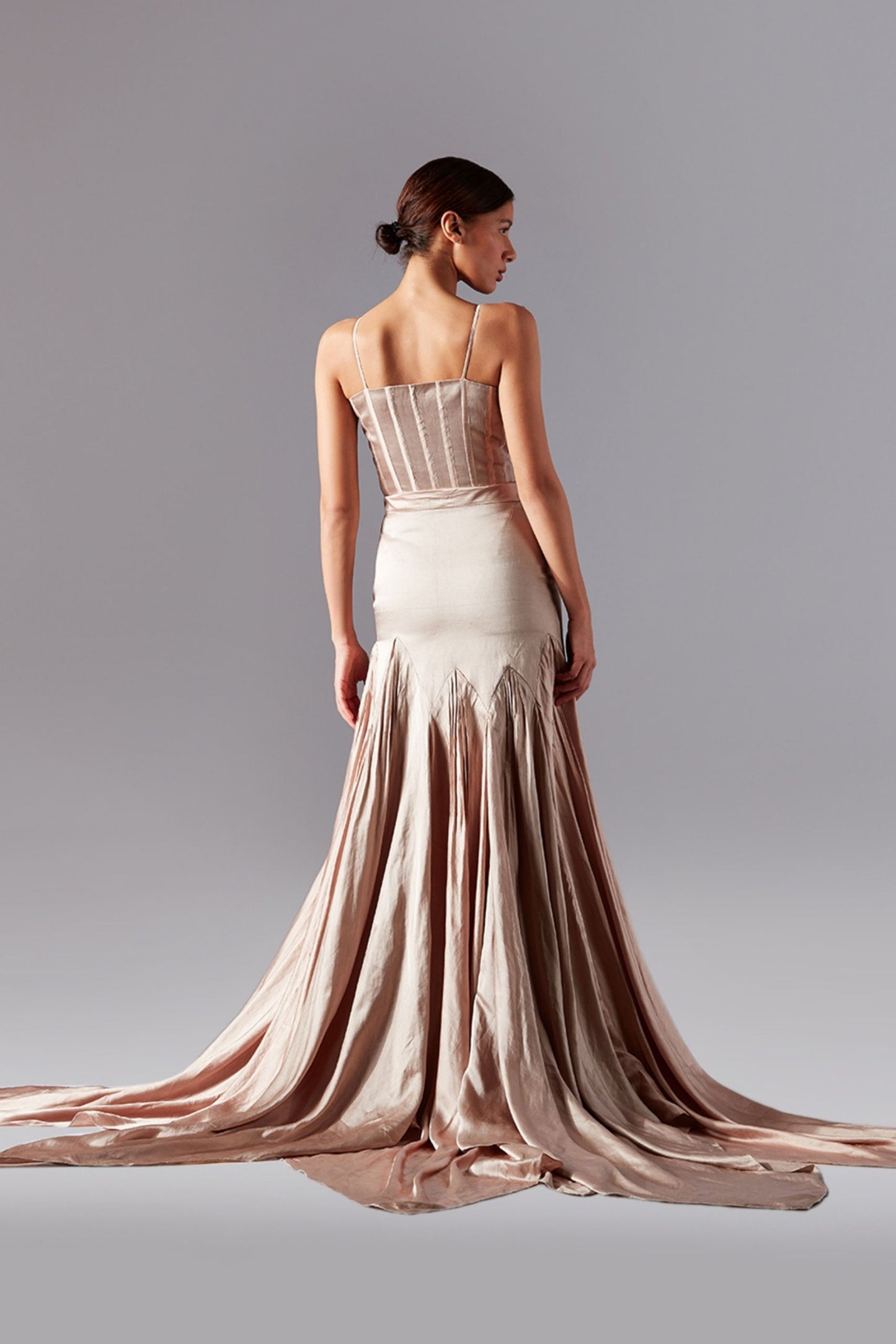 Back view showing the corset and flowing trail skirt, emphasizing the chic design of the party wear set