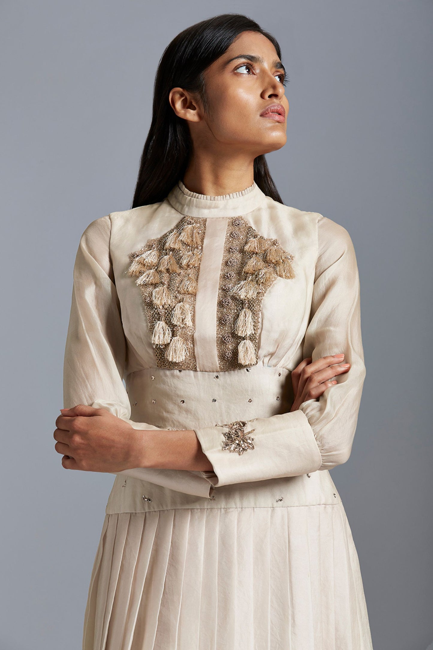 Close-up of the intricate handmade Mukaish work and pleating details on the Victorian gown