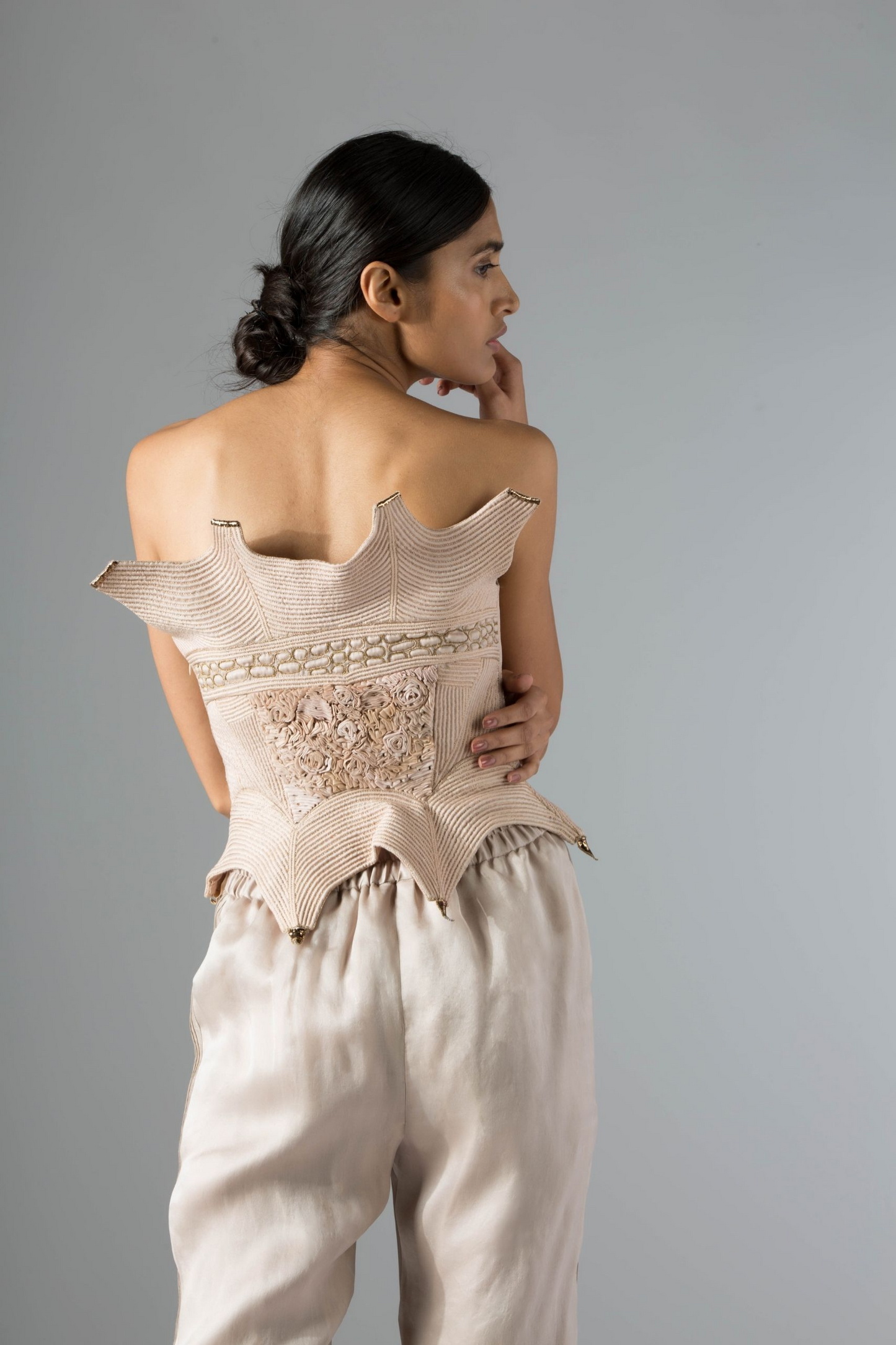 Back view of the Dune corset top, showcasing its fitted design and the detailed inlaid dori and mukaish embroidery