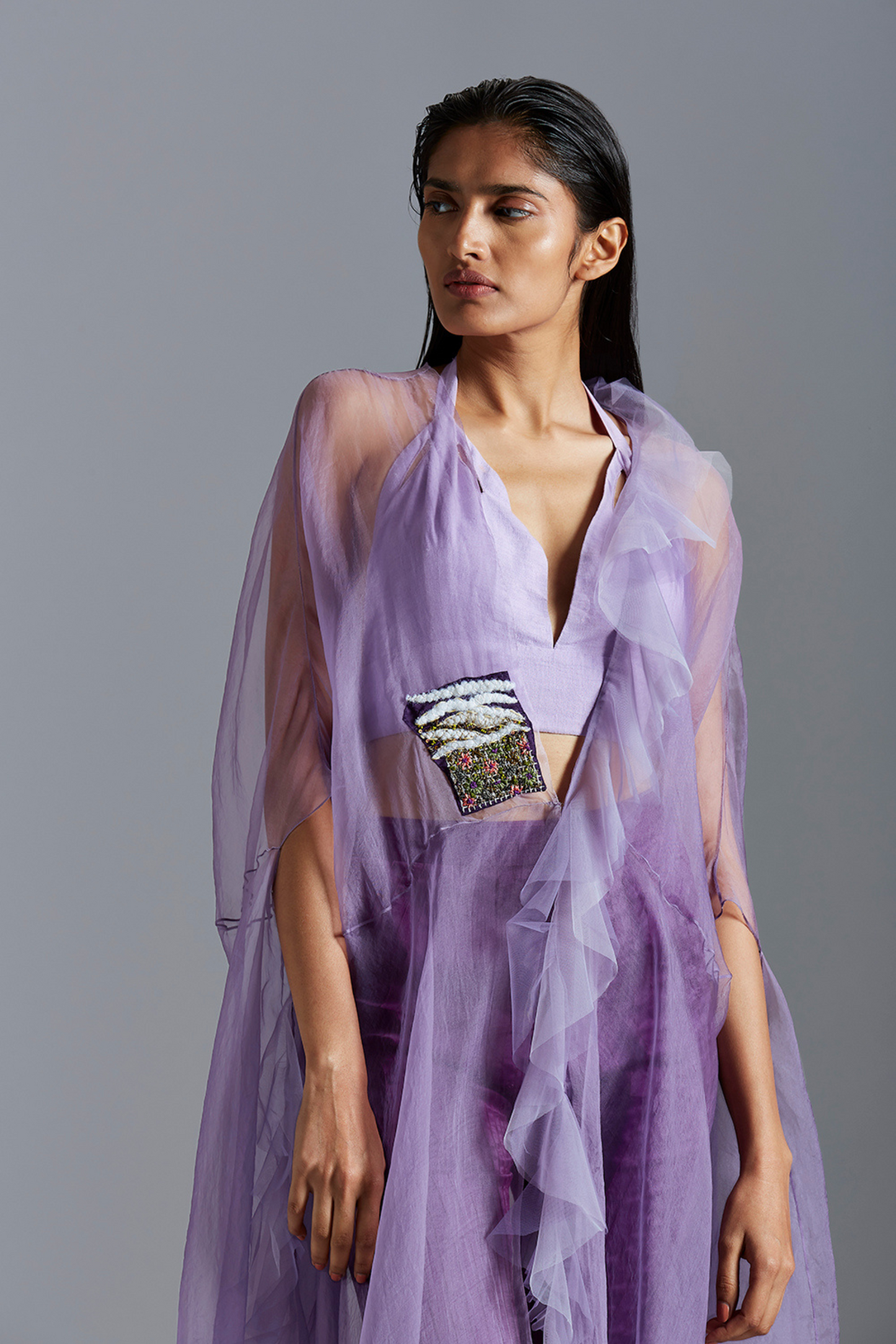 Close-up of the handcrafted embroidery on the cape, highlighting the intricate detailing and design