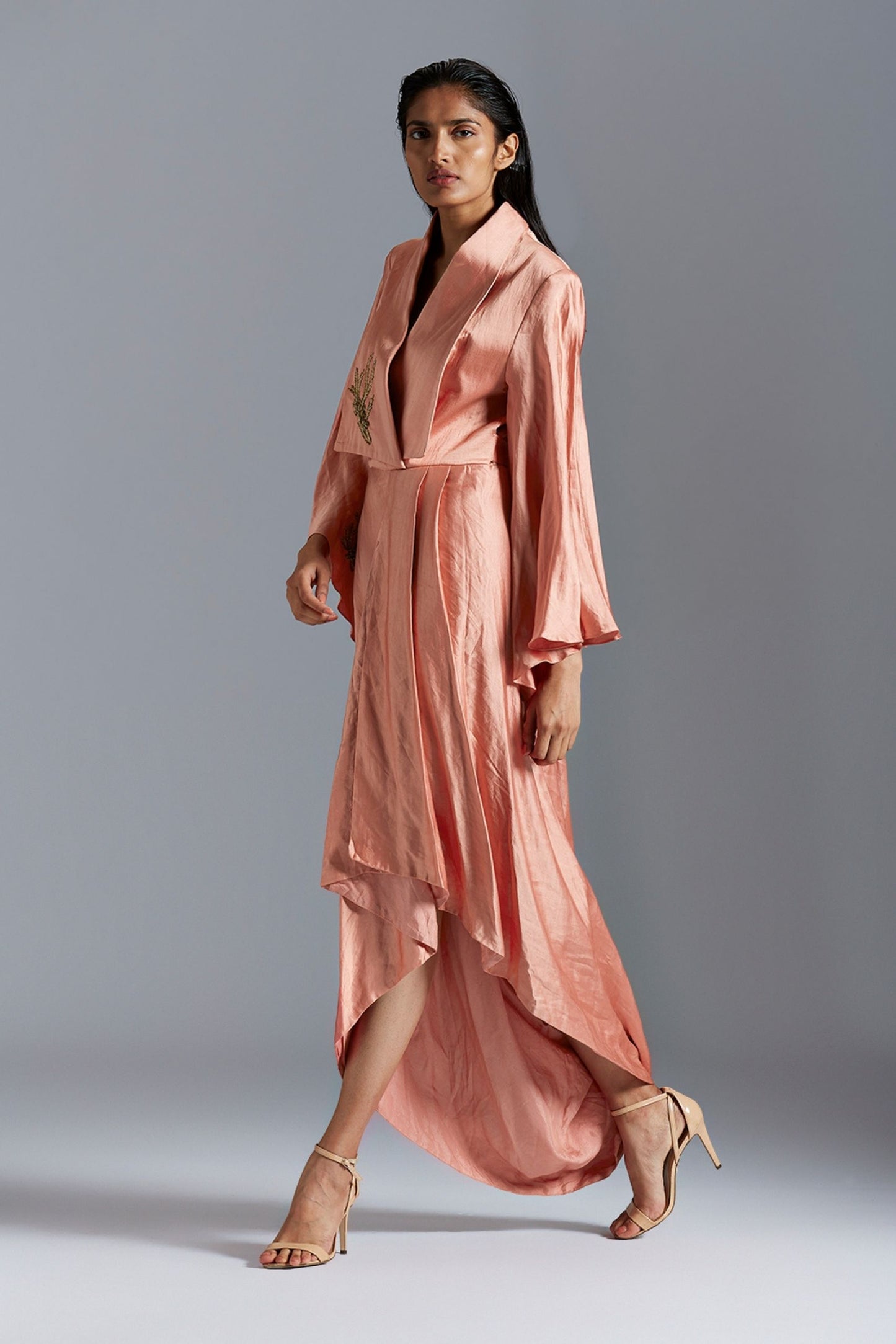 Iconic draped dress for women with golden metallic detail, showcasing a modern and elegant design