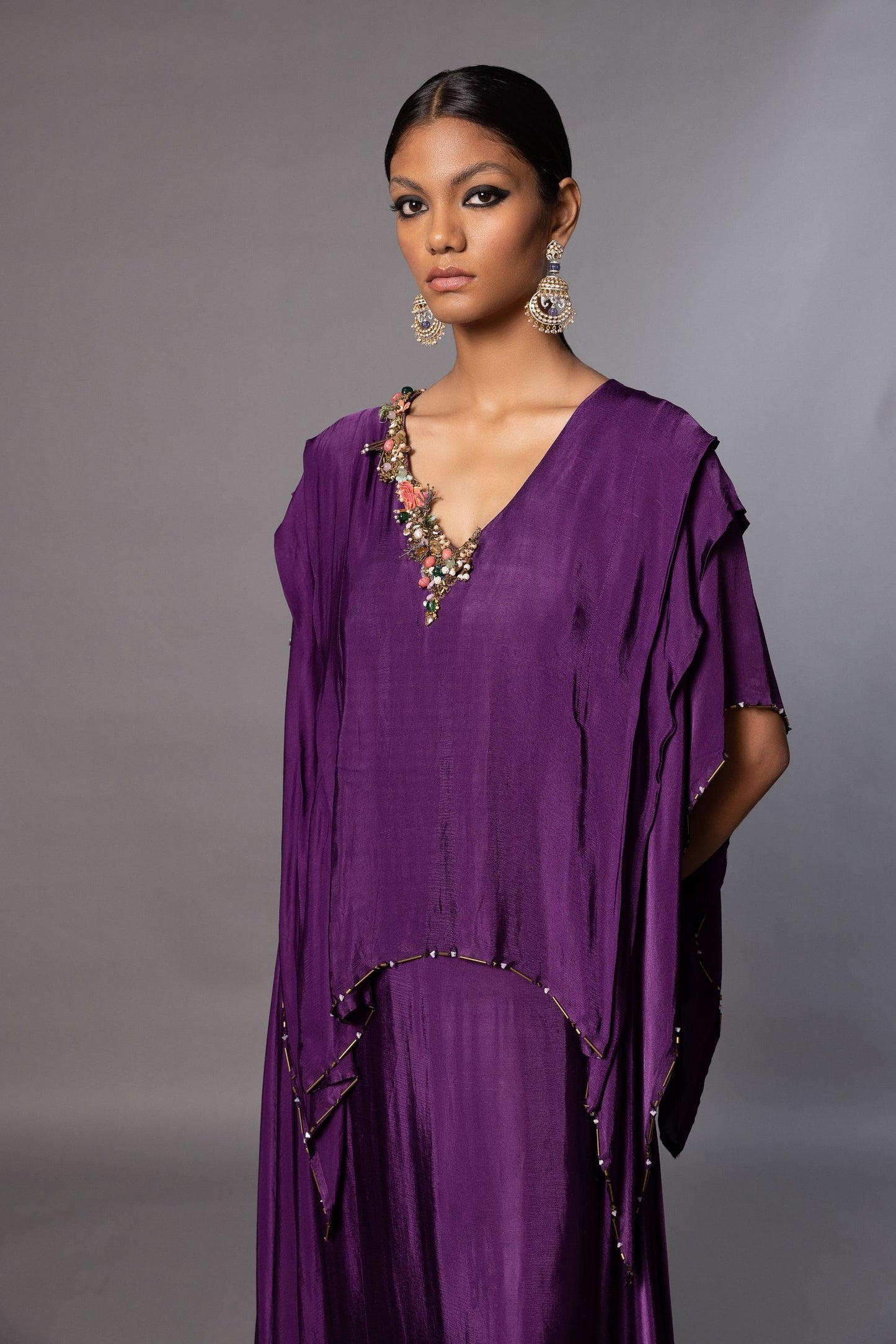 Close-up of the embroidered details on the Iris Kaftan Gown, showcasing natural stones, pearls, and metal beads