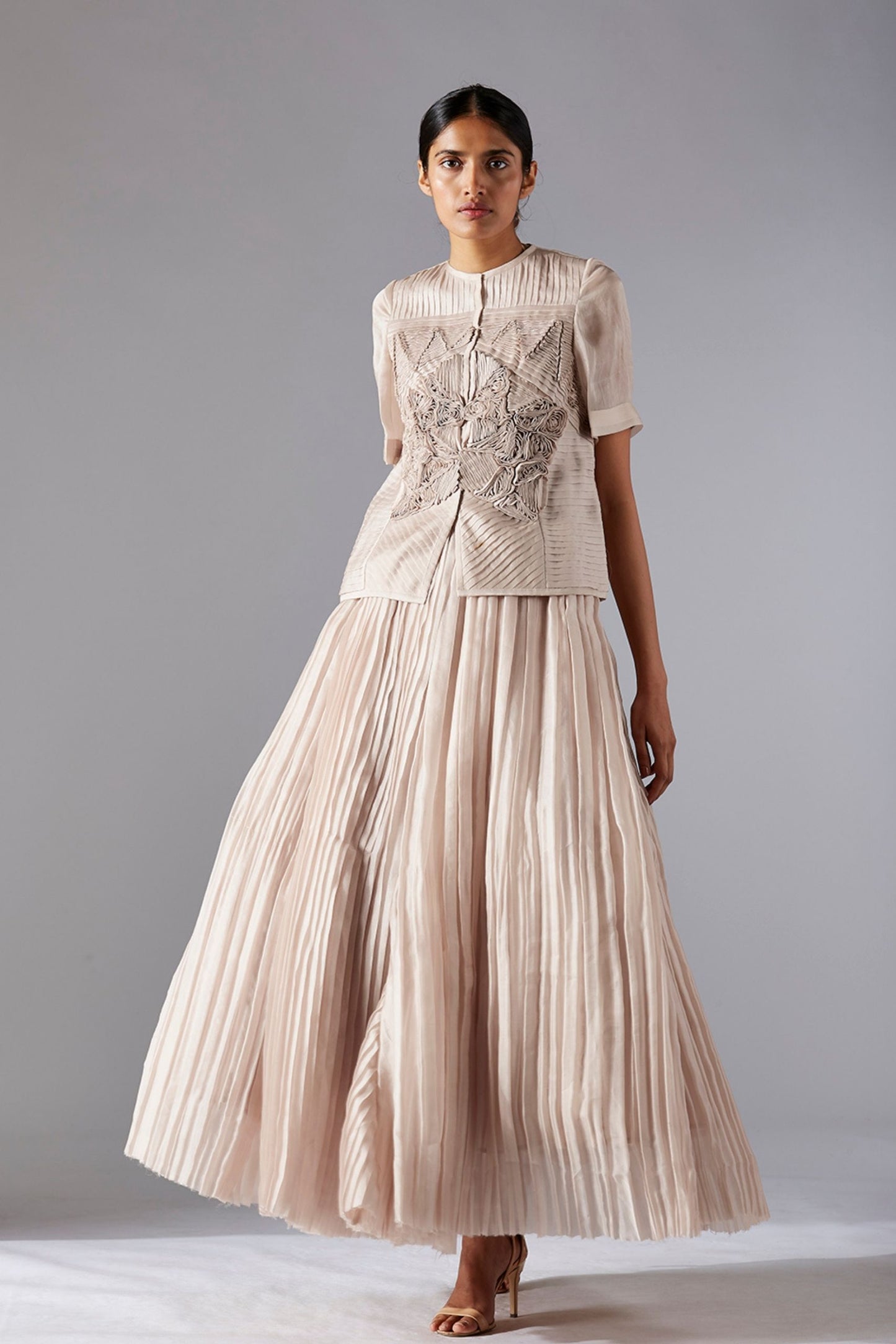 Designer sheer jacket with geometric details paired with a grandeur pleated ballroom skirt, offering a stylish and elegant look for women