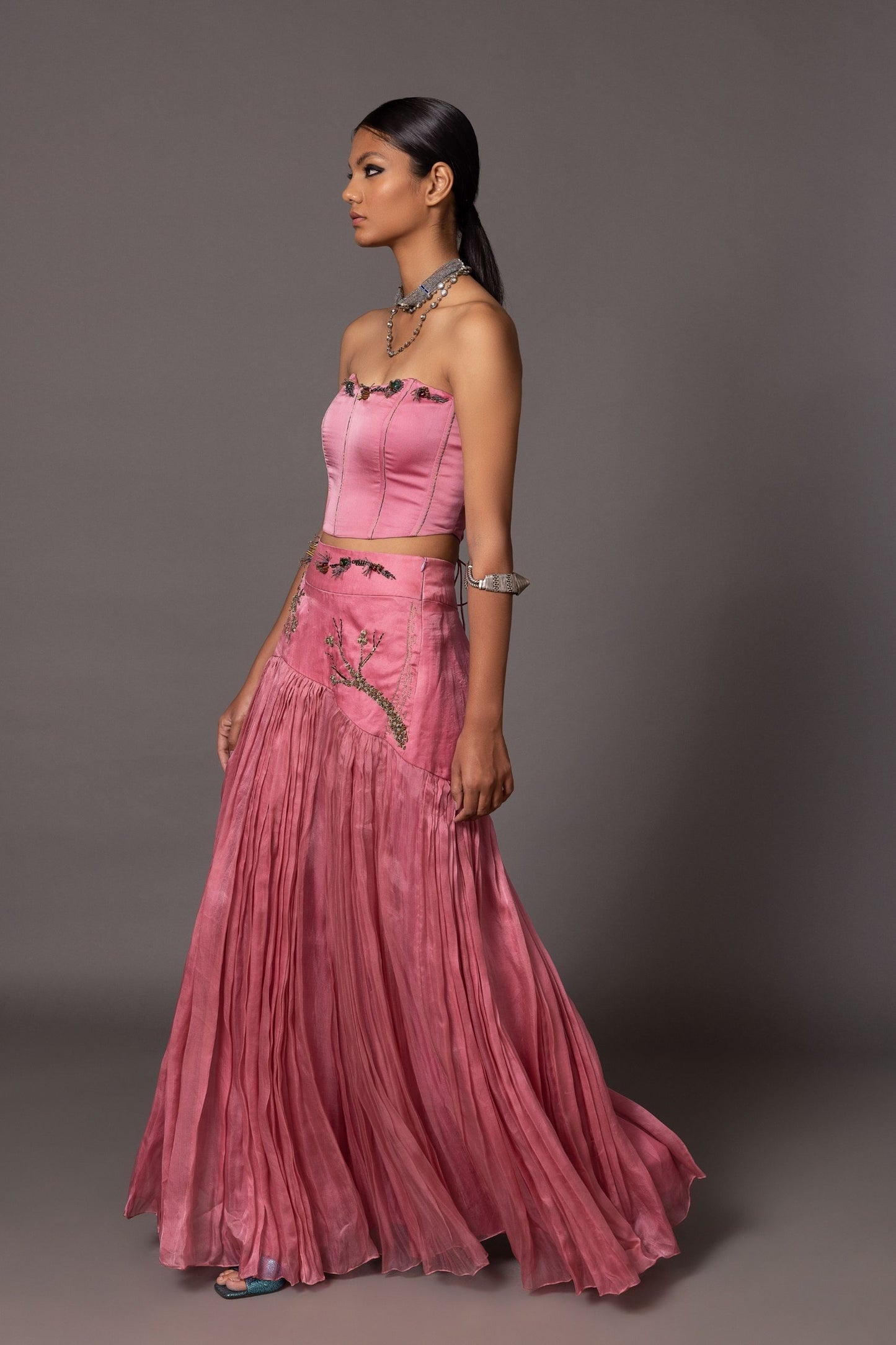 Side view of the Kaner Pink Corset Top & Skirt, highlighting the corset design and the flow of the skirt