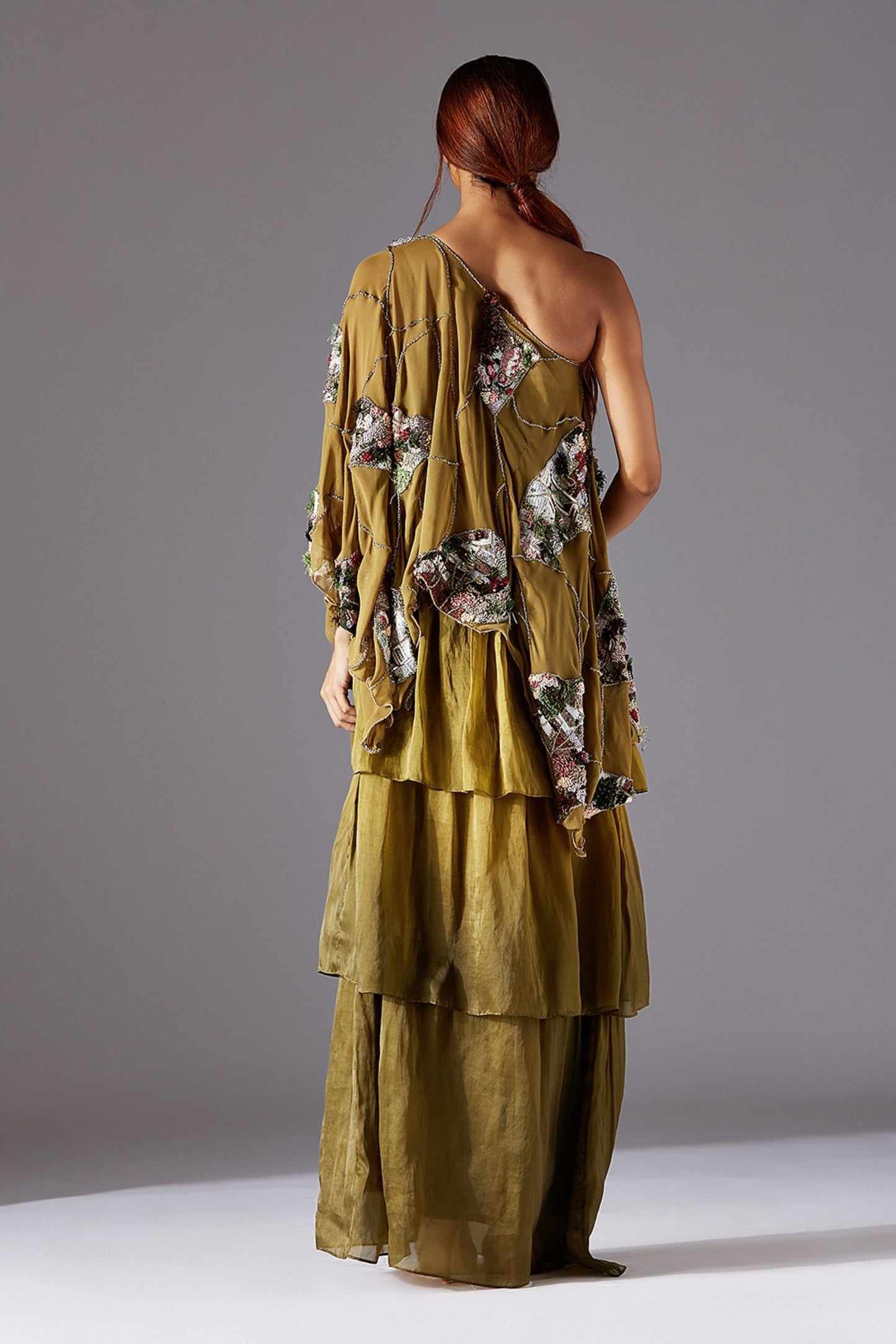 Back View of One Shoulder Cape & 3-Tiered Dress with Concealed Zip and Luxury Details
