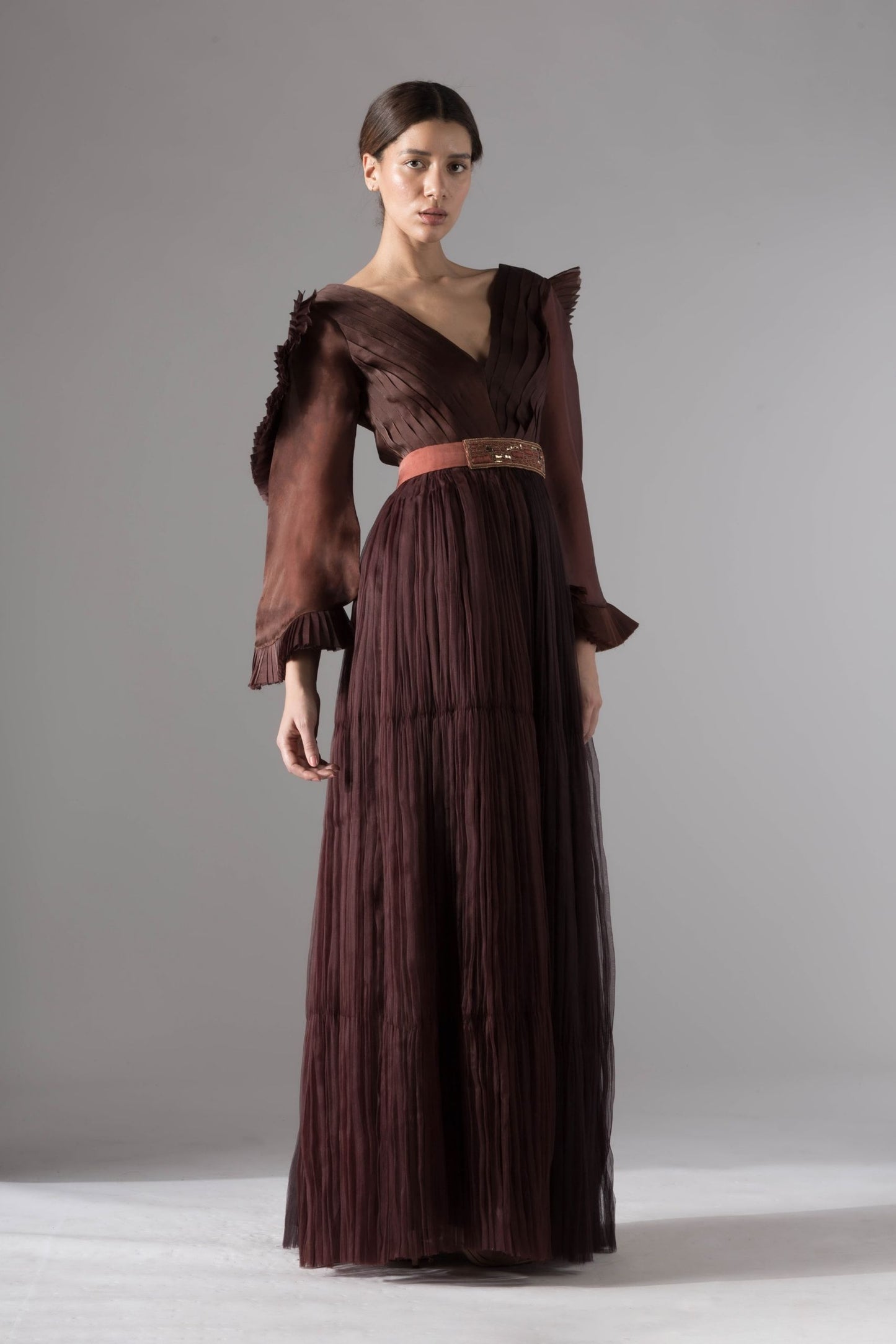Full view of the elegant evening gown with statement sleeves, showcasing the flattering pleated ruching and rope-inlay belt