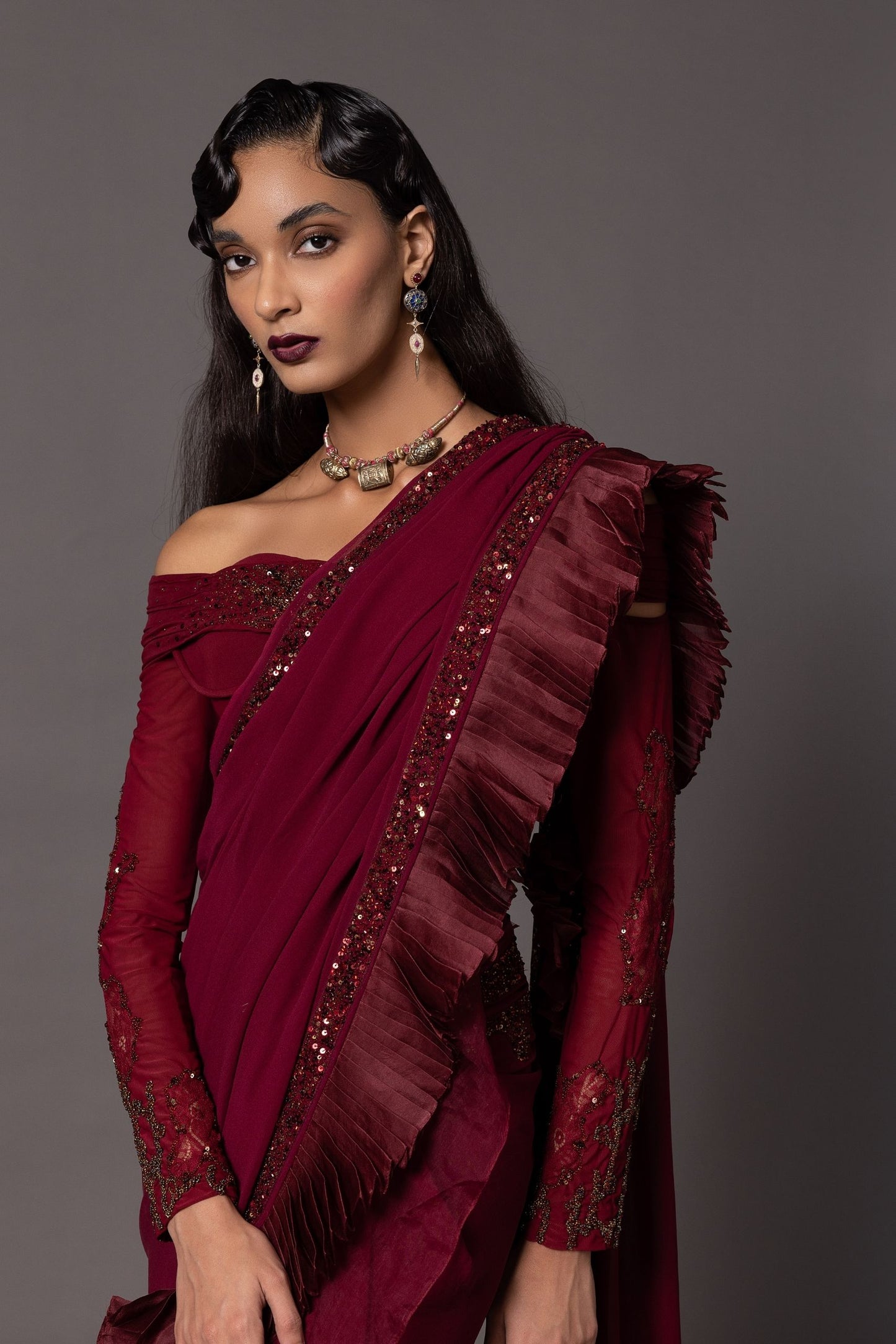 Intricate beadwork and embroidery on a maroon sequin saree blouse – a luxurious off-shoulder blouse style