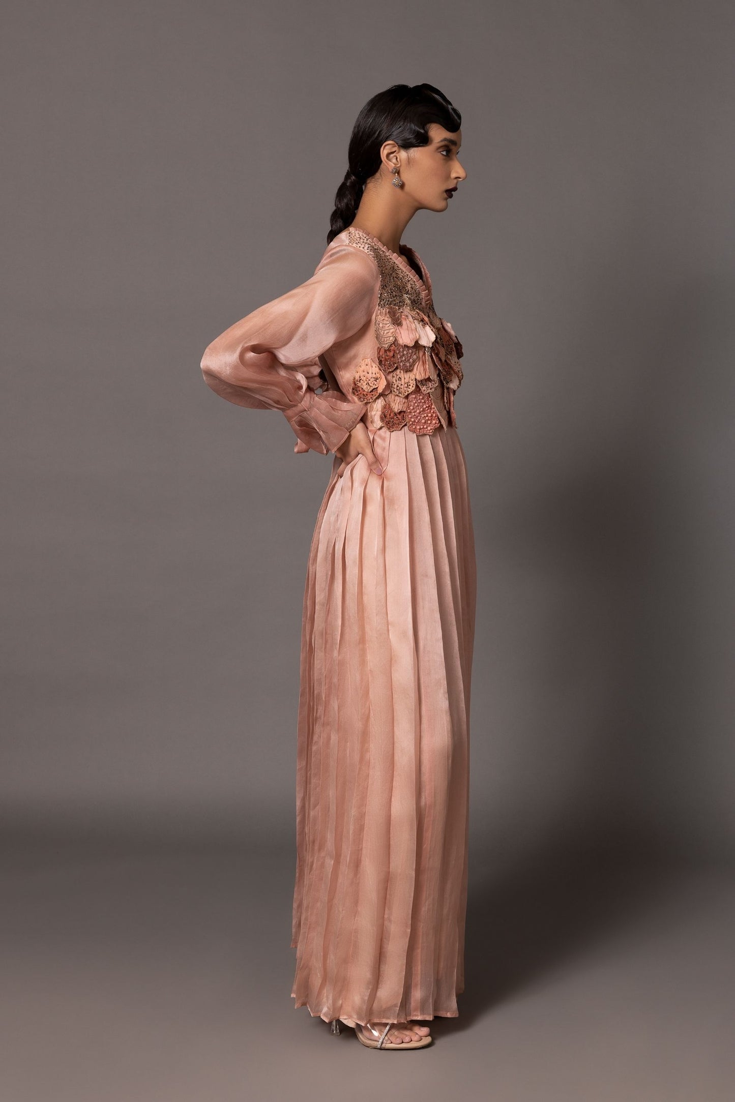 Side view of the Mima Mounds Pink Gown, emphasizing the silhouette and the flow of the pleated fabric