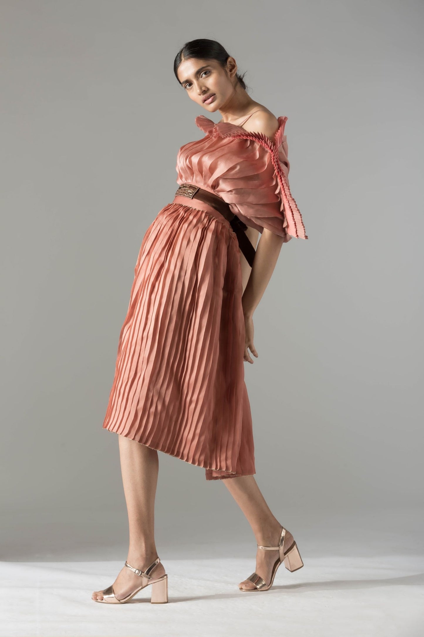 Modern mushroom design off-shoulder top and pleated skirt with rope-inlay belt, creating a chic and stylish look for women