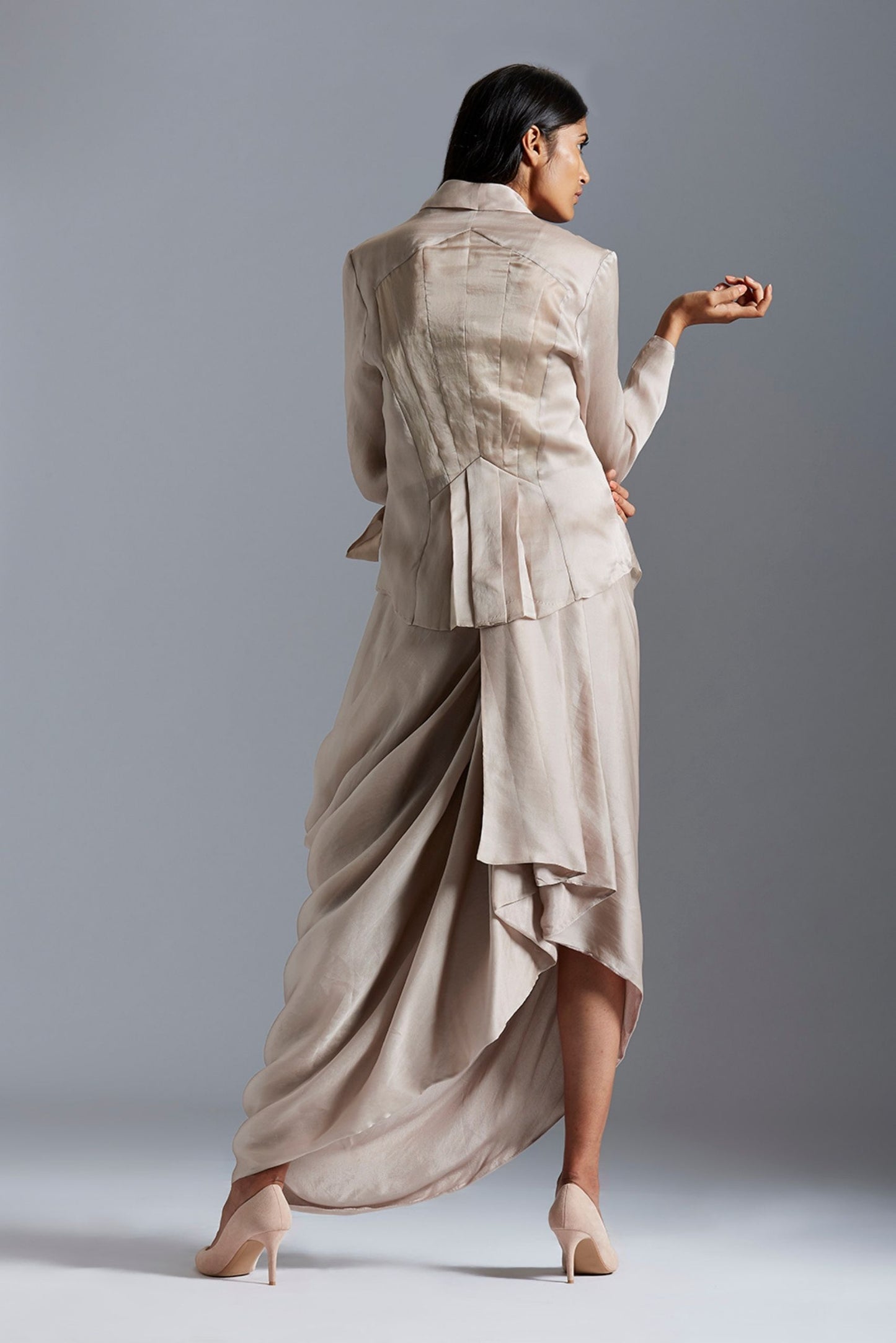 Back view of the designer jacket and drape skirt, showcasing the elegance of the silhouette and embroidery details