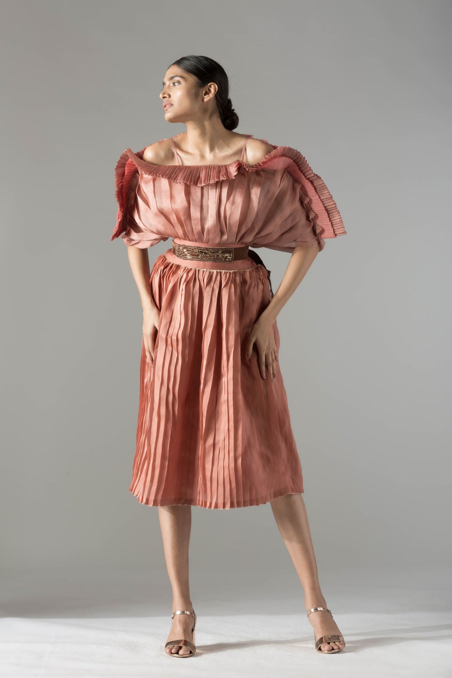 Stylish off-shoulder mushroom top paired with a pleated skirt and rope-inlay belt, offering a modern and chic look for women