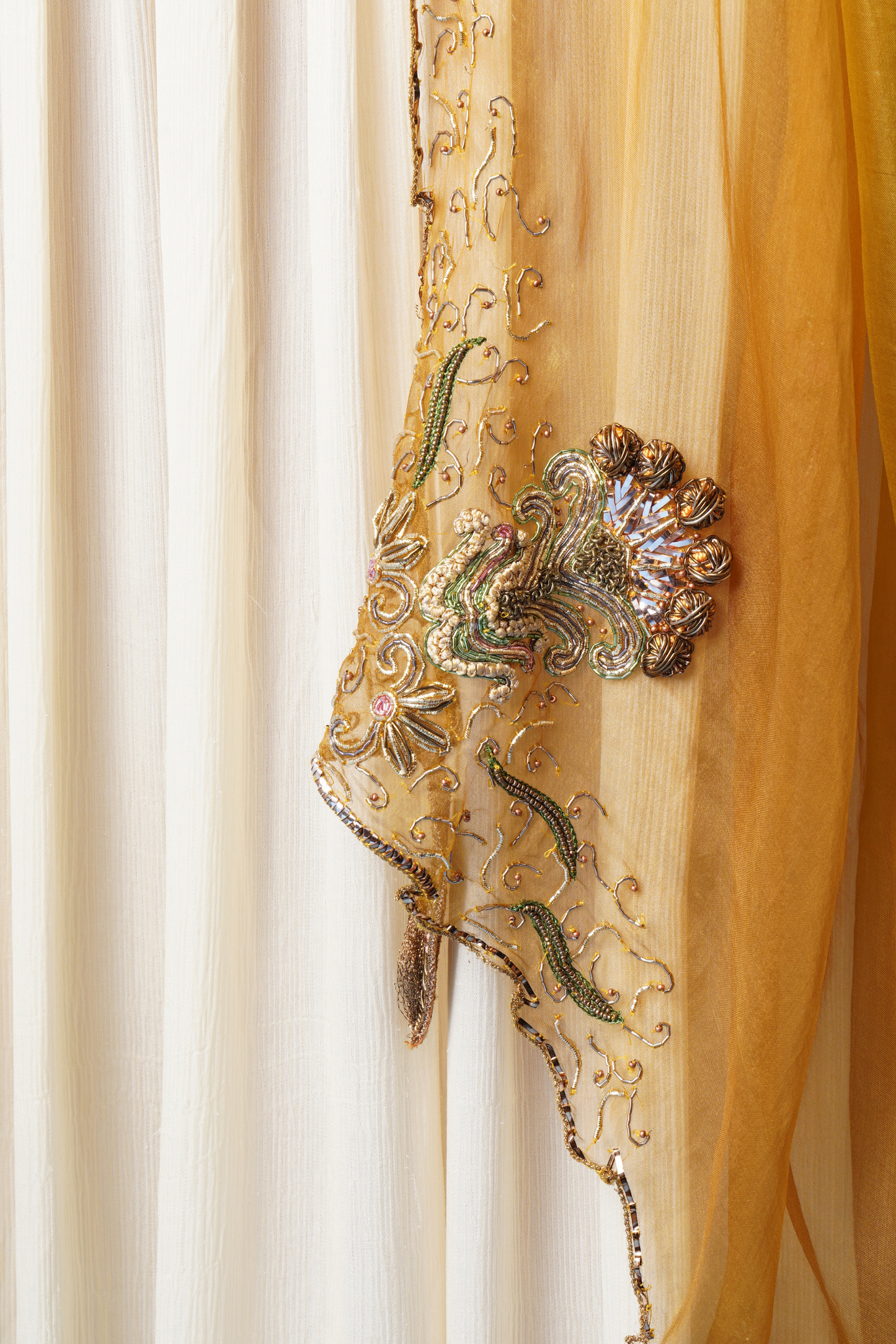 Detailed view of the embroidered dupatta worn with the ivory gown for women
