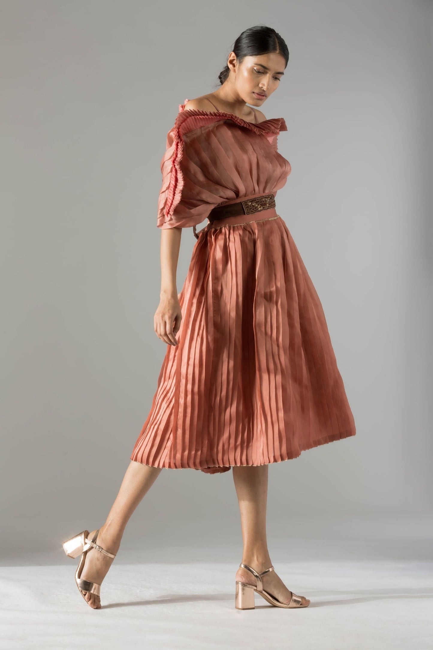 Full view of the stylish off-shoulder mushroom top and pleated skirt for women, highlighting the complete modern look