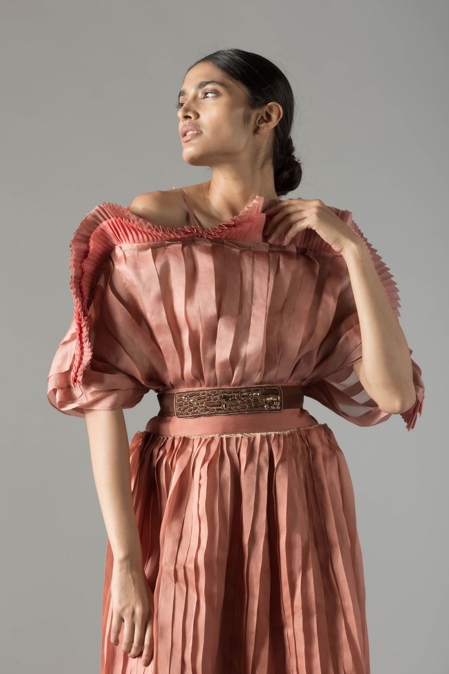 Close-up of the rope-inlay belt and pleated skirt details, paired with the off-shoulder mushroom top, showcasing modern design