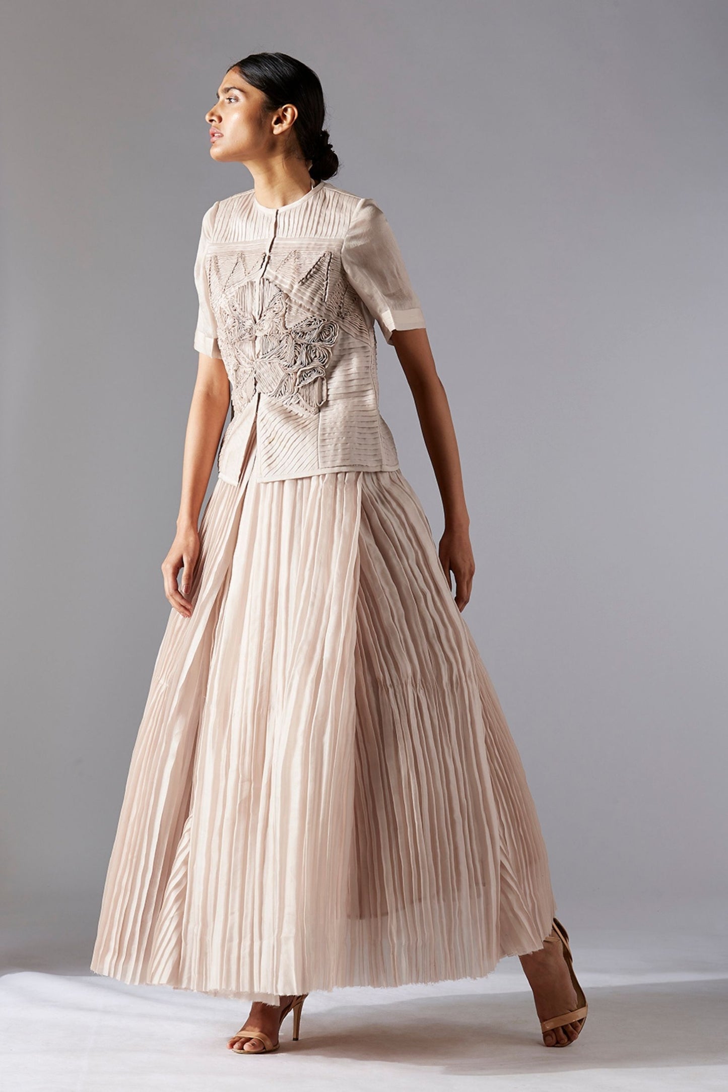 Stylish designer sheer jacket with geometric details, paired with a grandeur pleated ballroom skirt for an elegant look